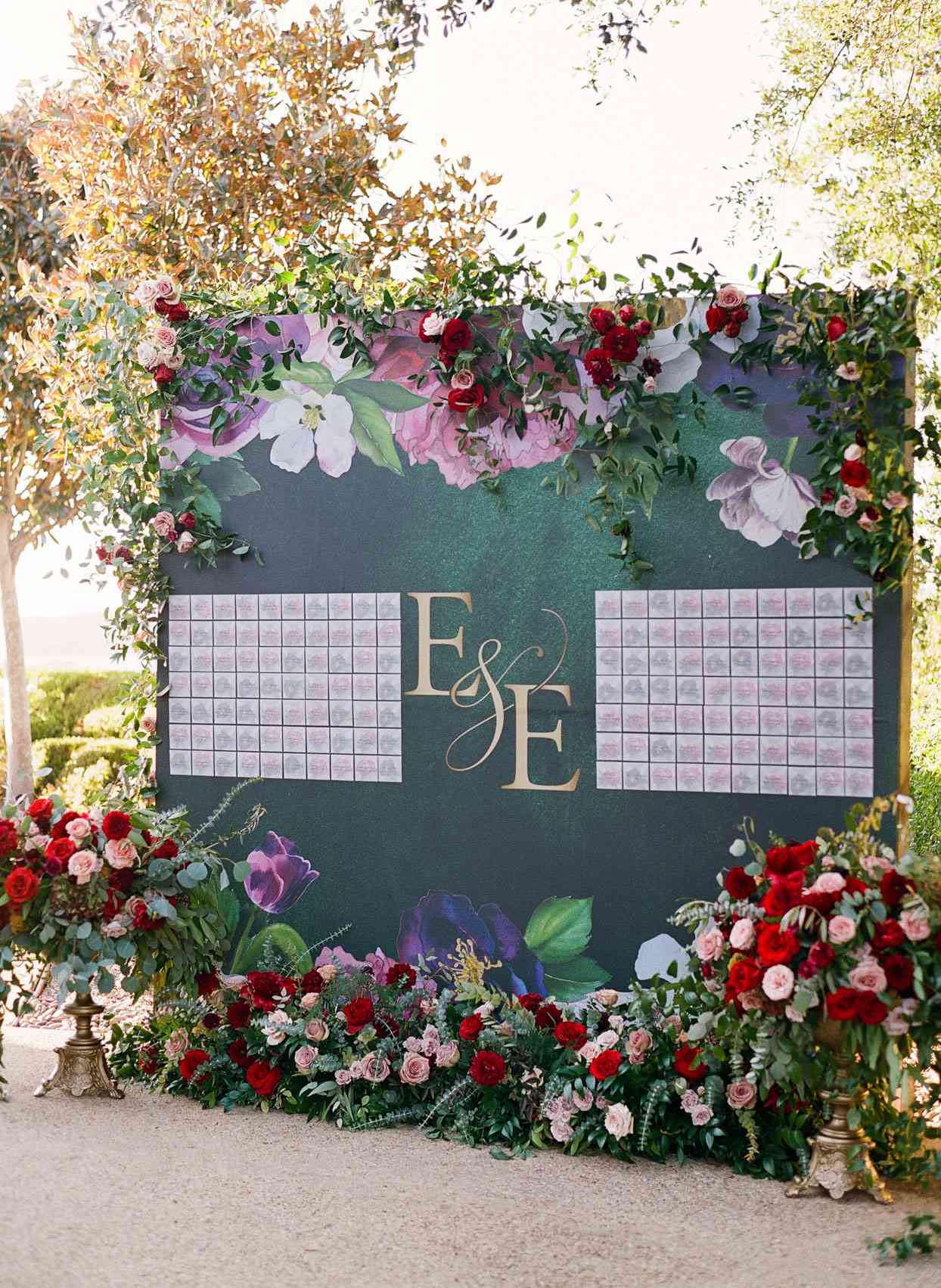 wedding seating chart board surrounded by flowers