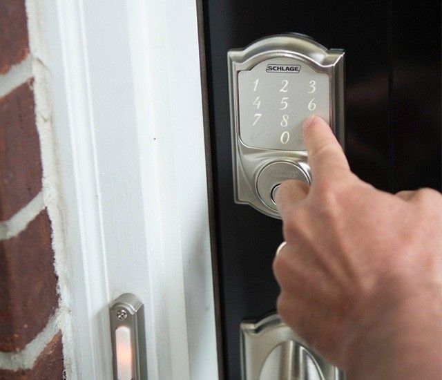 smart lock in nickel on door with someone unlocking