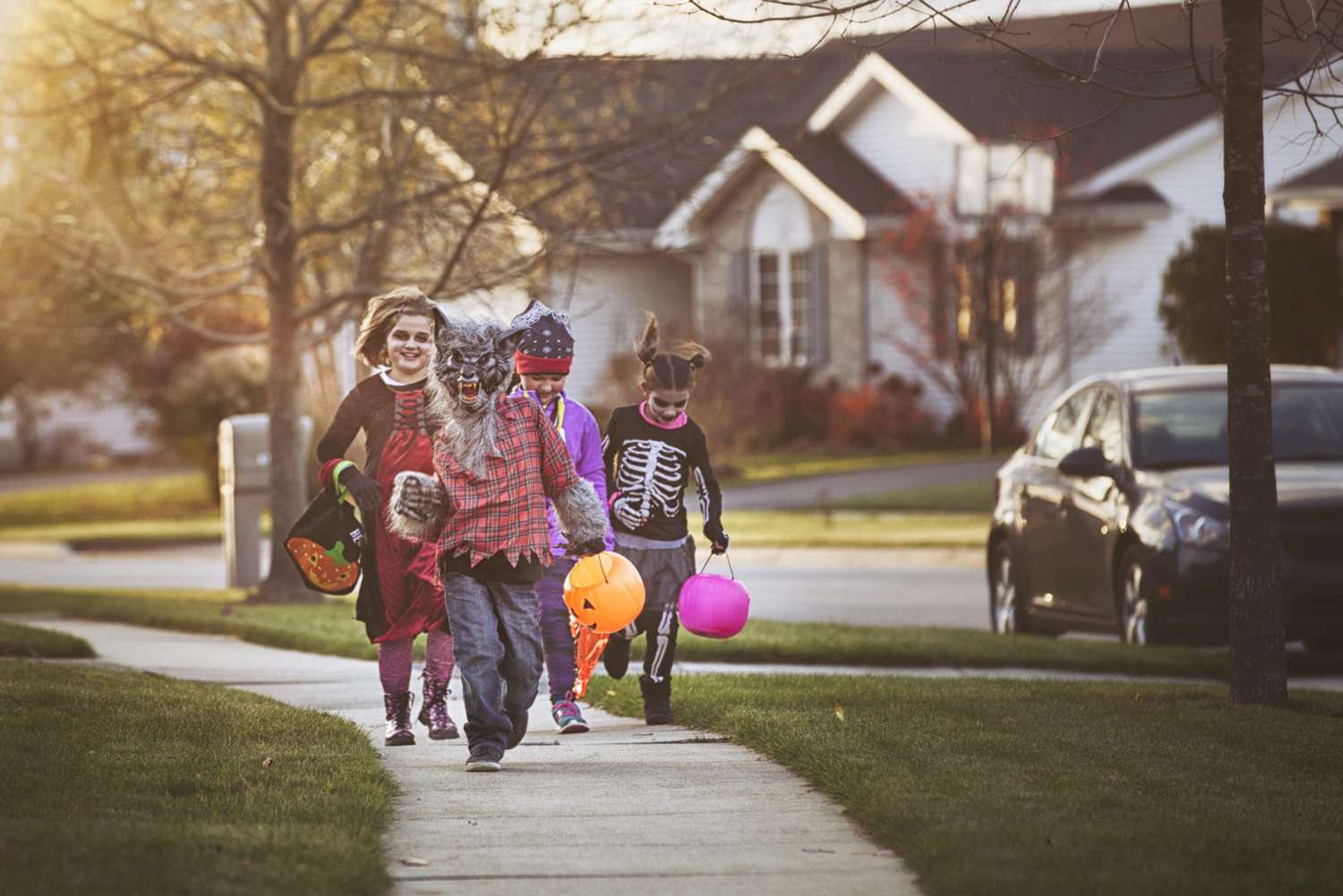children trick-or-treating in Halloween costumes outdoors
