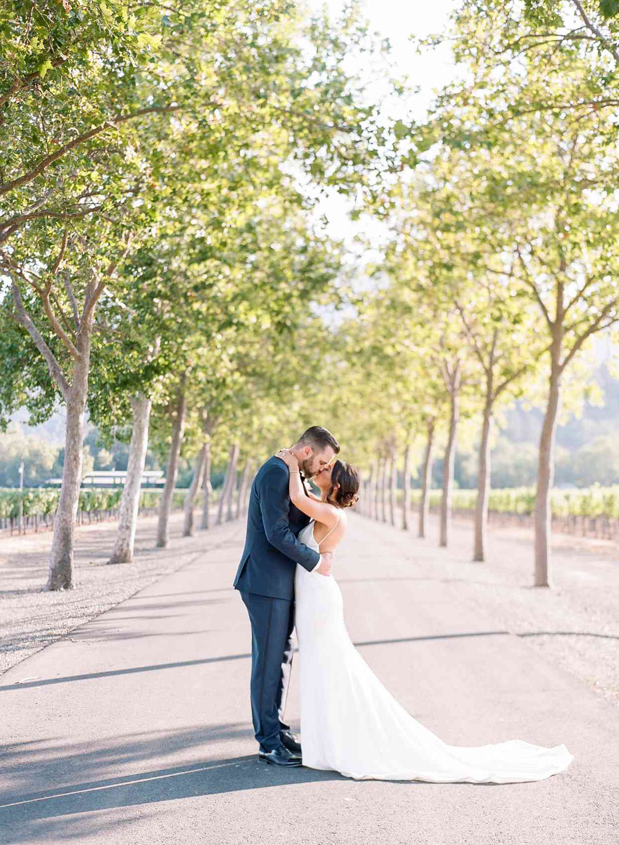 wedding couple portrait kissing in vineyard