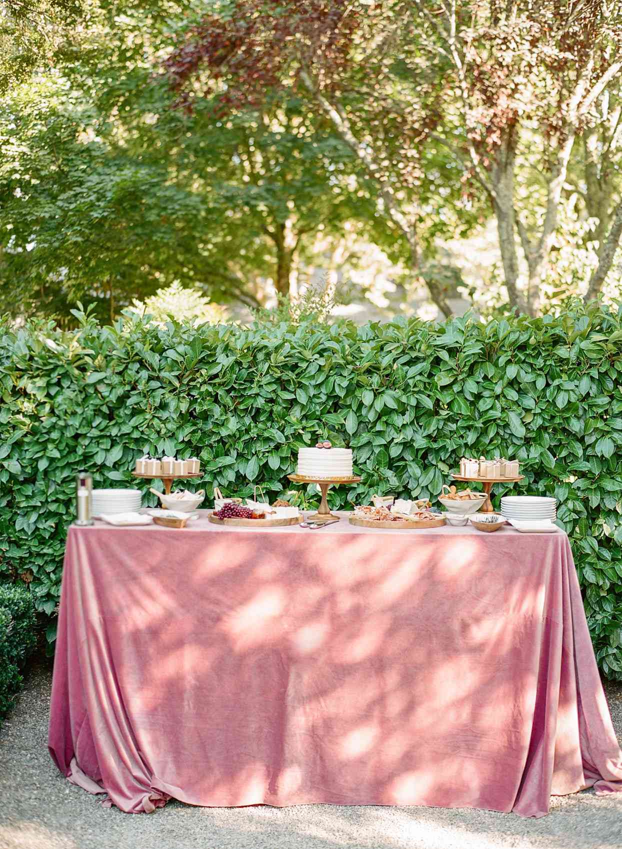 wedding food table with burgundy tablecloth