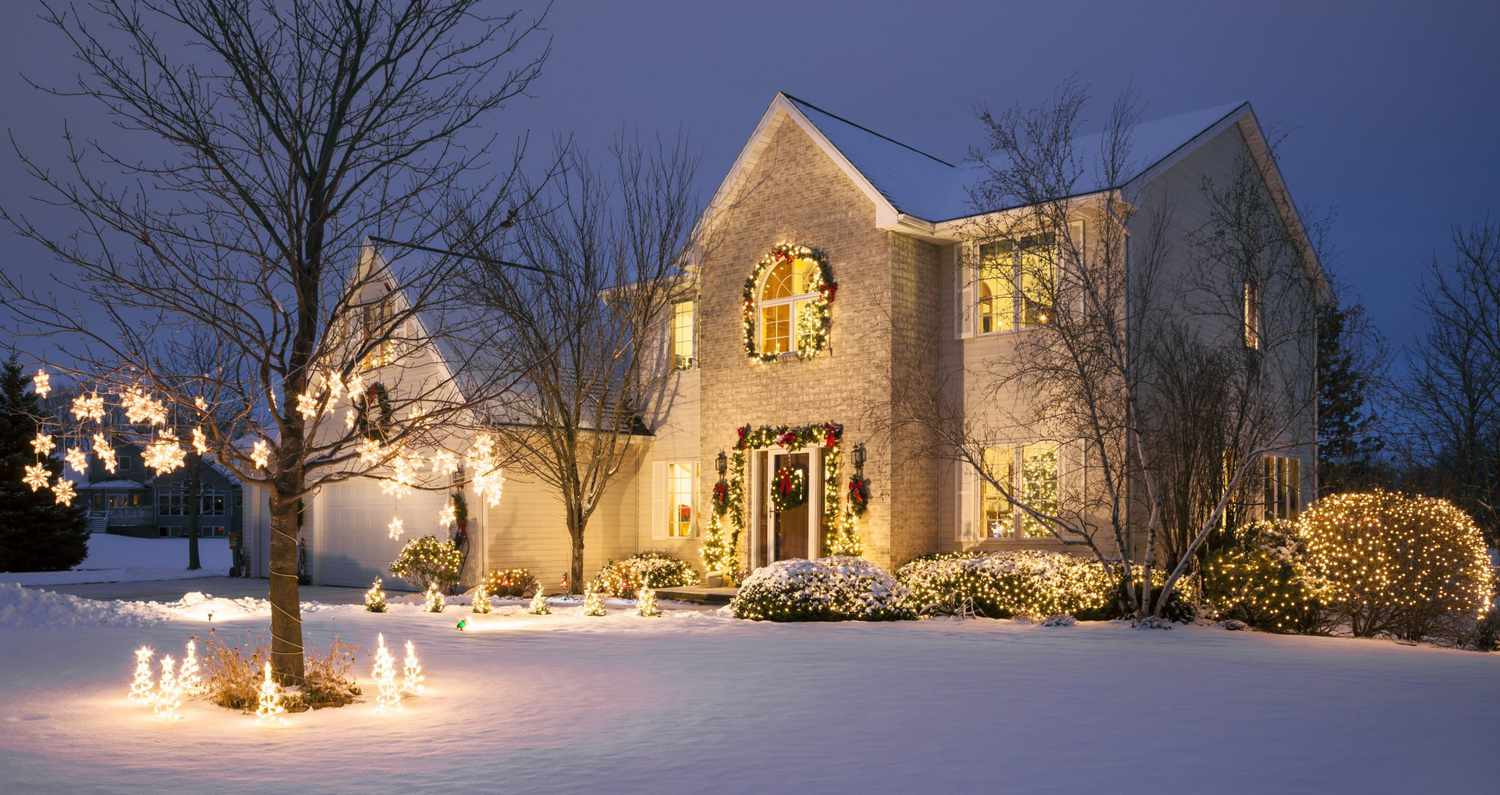 Christmas home with festive holiday lighting and snow