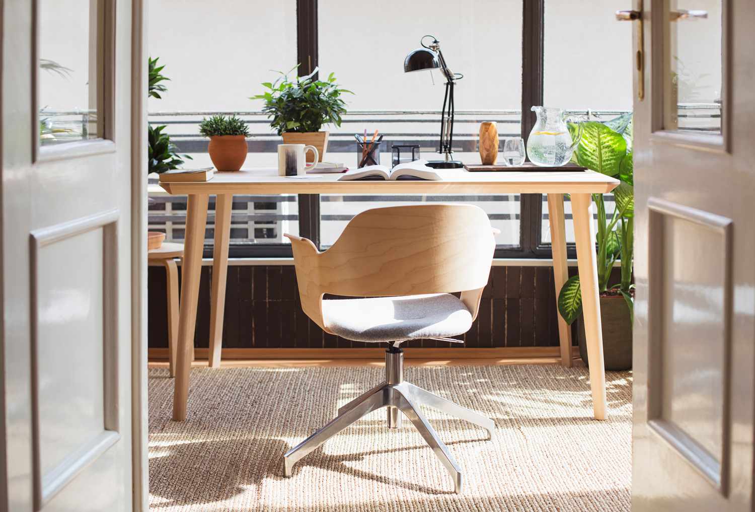 light brown wooden desk and chair set office space with various plants