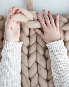 hands weaving top row of arm knit blanket