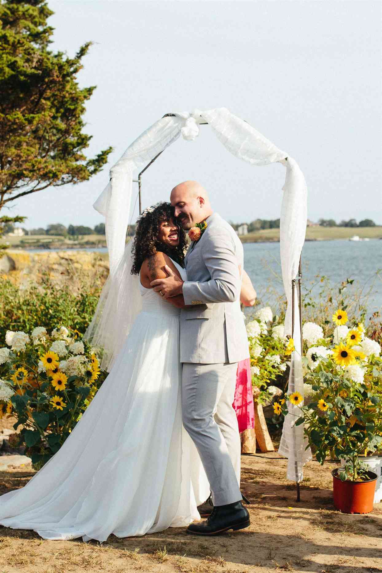 wedding couple hugging during ceremony vows