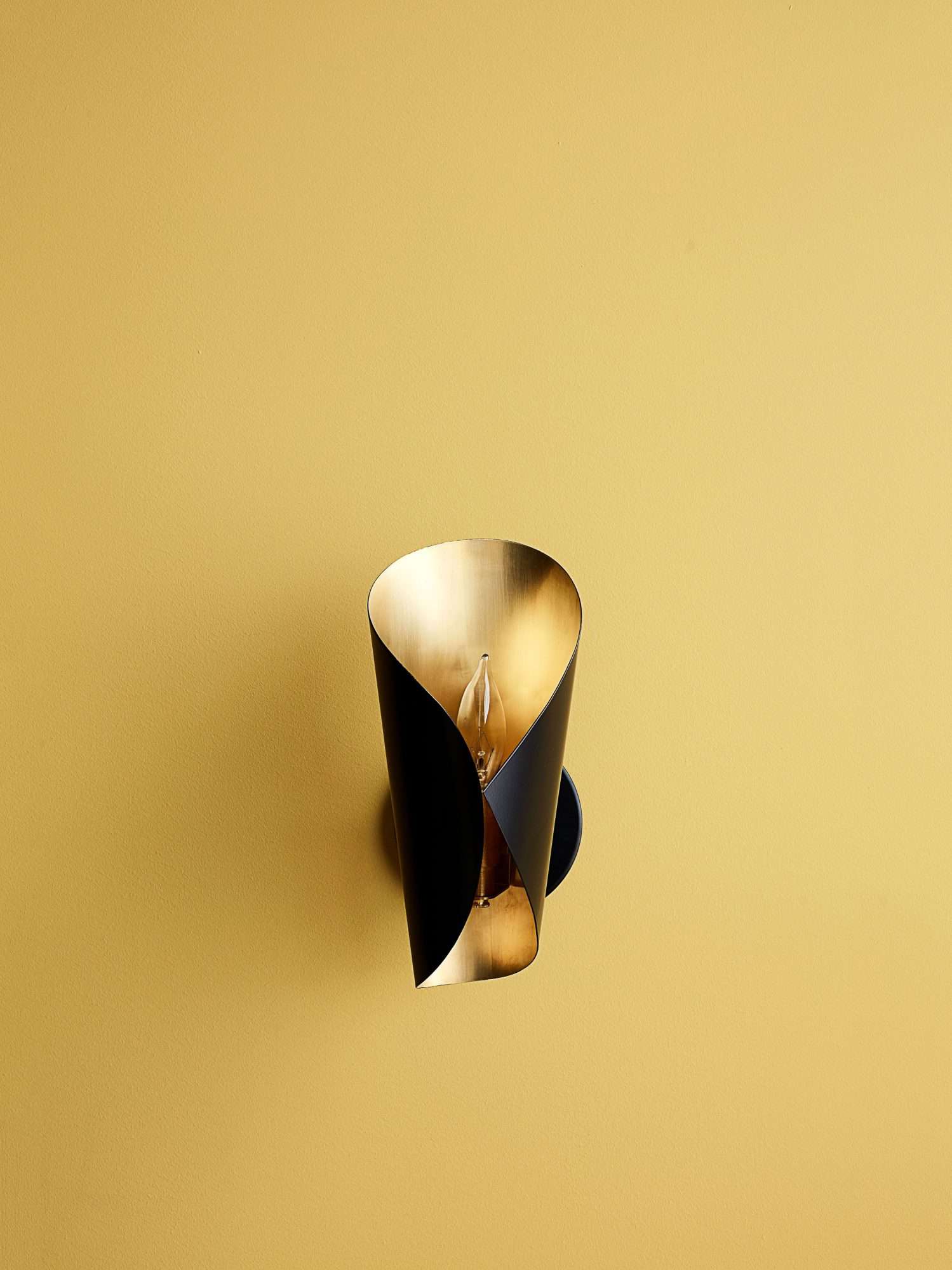 sconce light on a gold wall