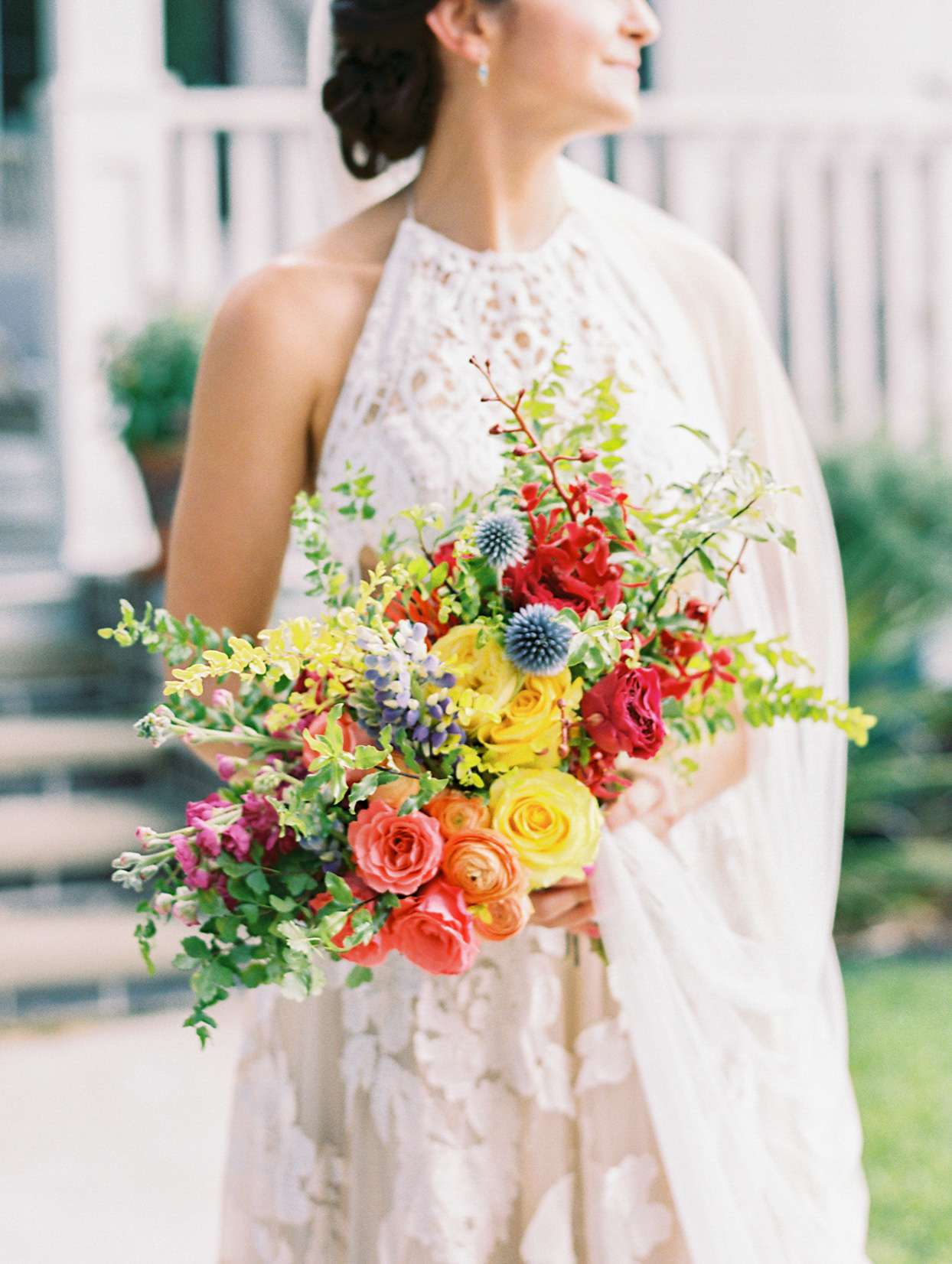 bride holding colorful wedding bouquet