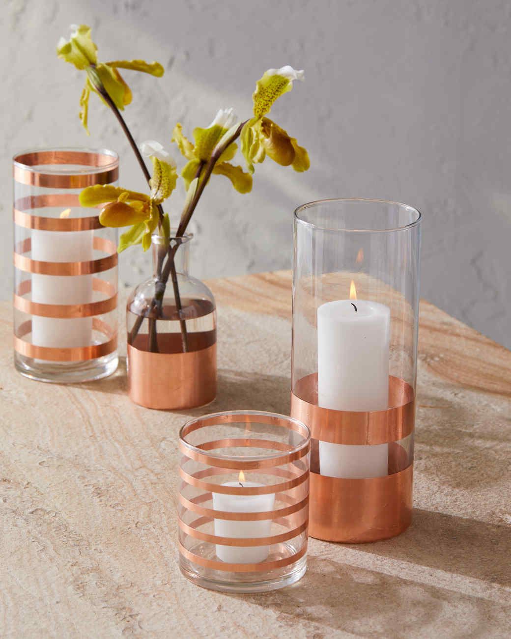 copper striped glassware containing candles