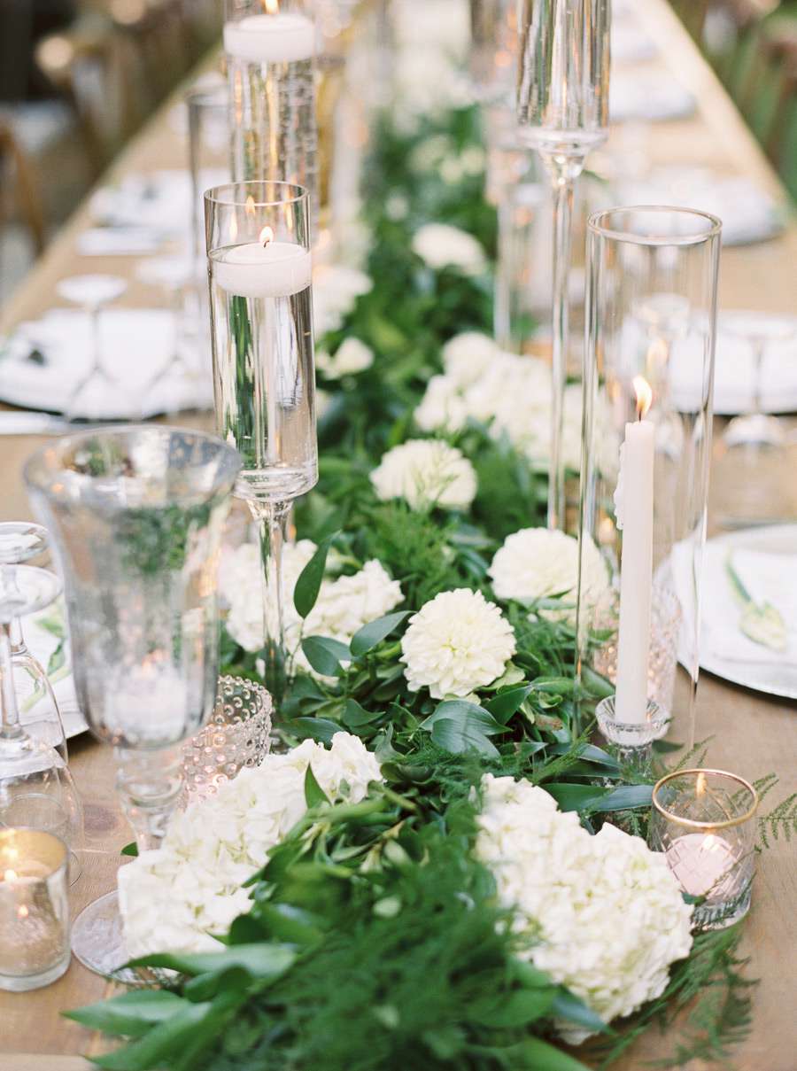white floral and greenery centerpiece on wedding table