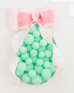 green balloons wrapped with pink bow easter egg shape