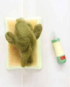 more felt applied to green cactus on felting mat