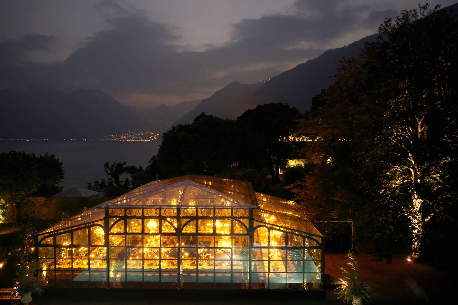 brightly lit greenhouse wedding reception on mountain coast
