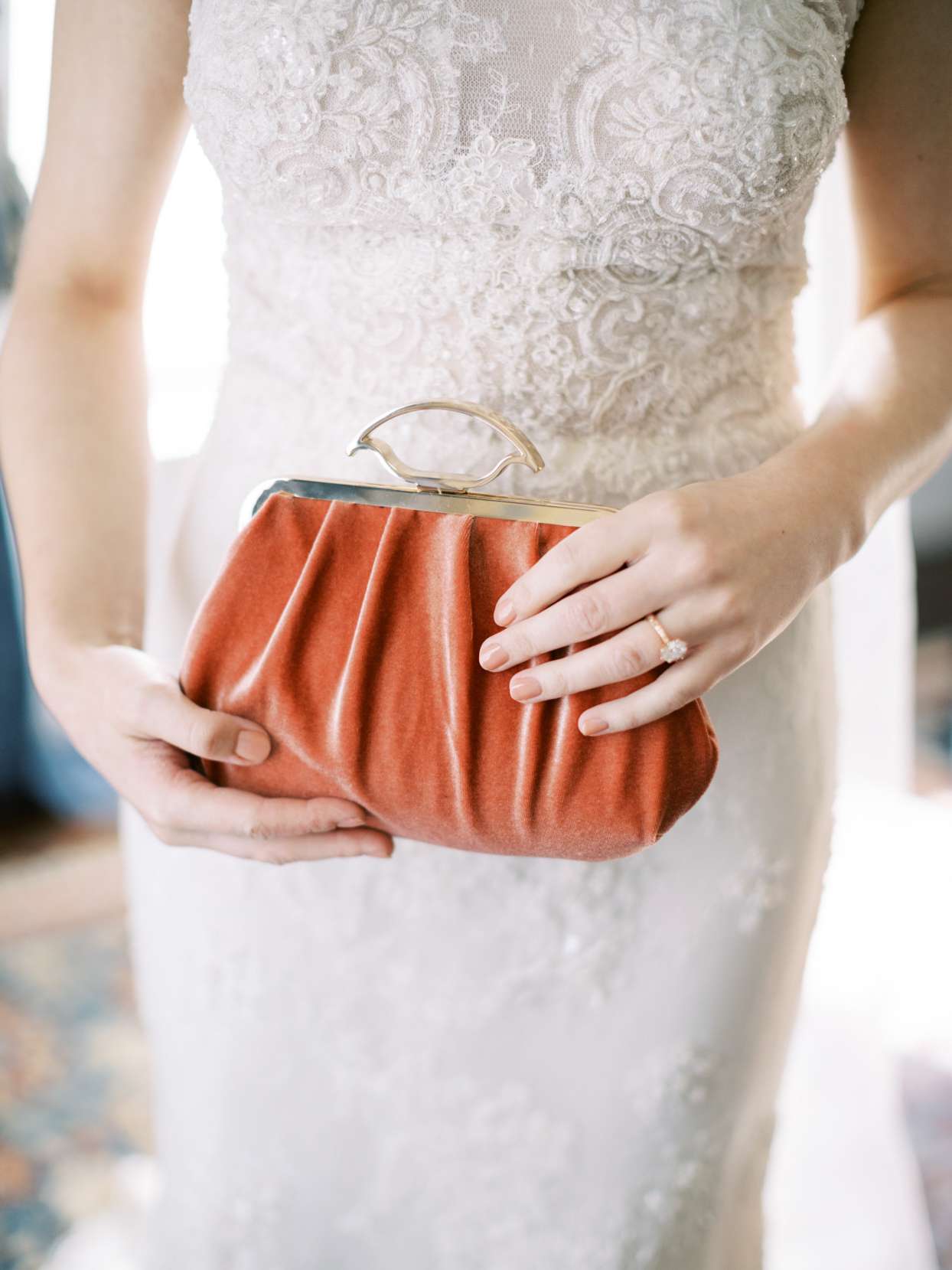 bride holding vintage velvet clutch