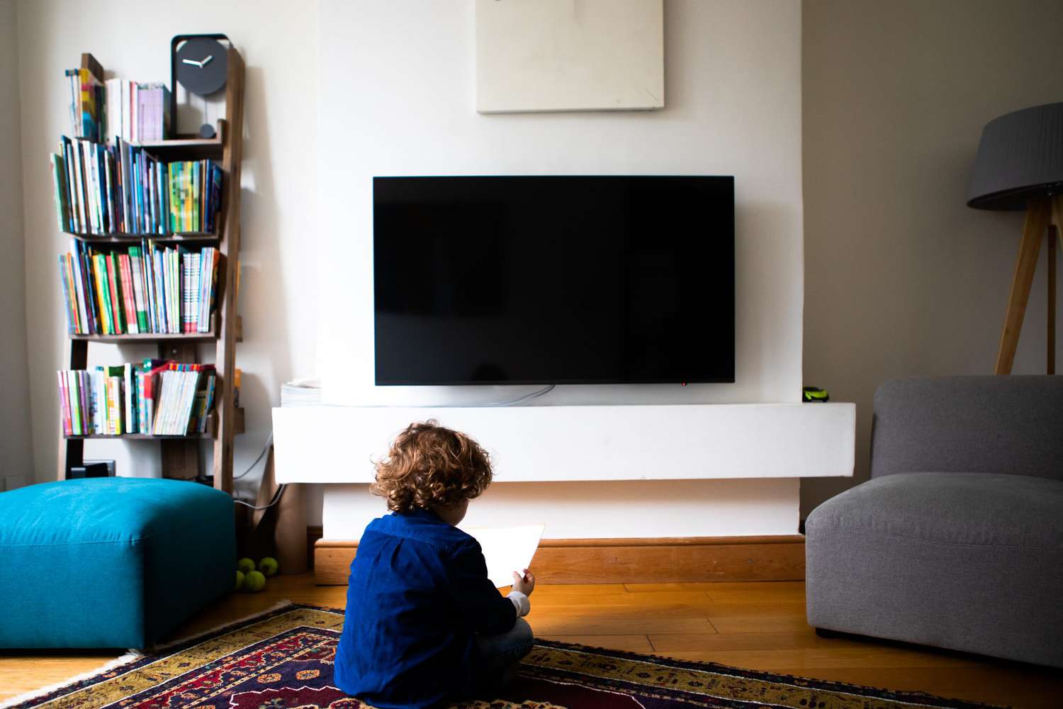 child in living room in front of tv