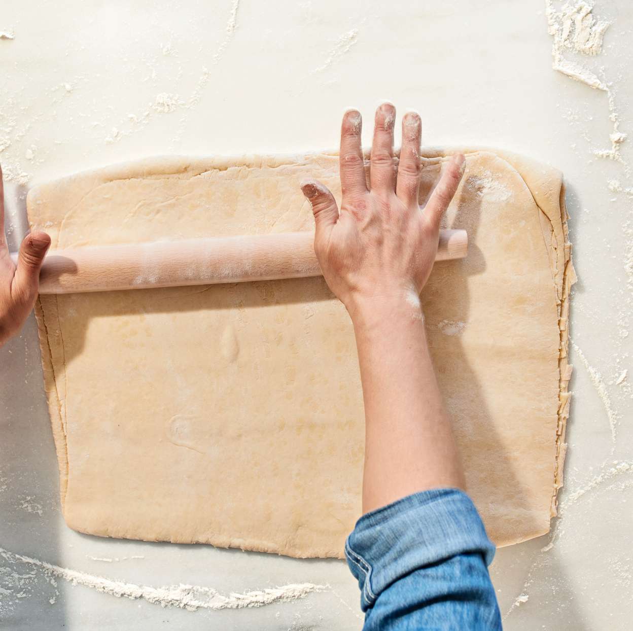 rolling out croissant dough