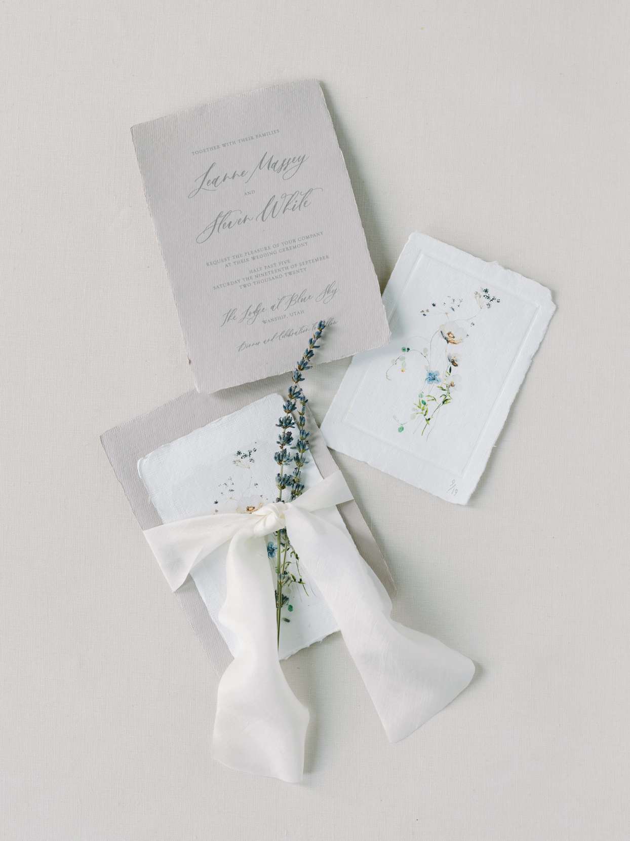 raw edge white wedding invites with blue floral design