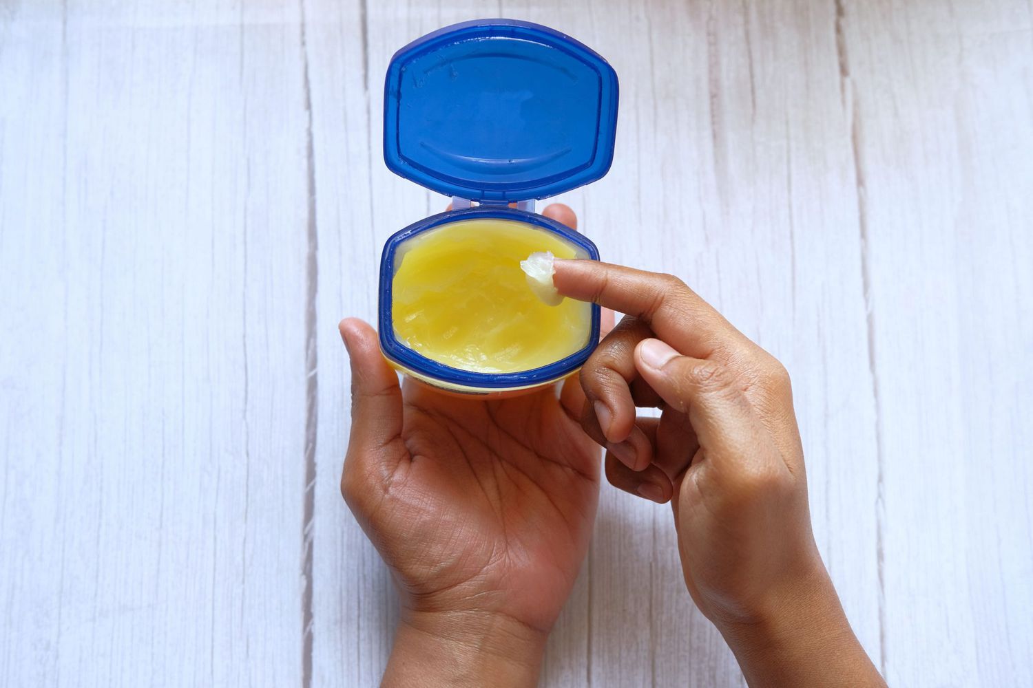 scooping vaseline out of container