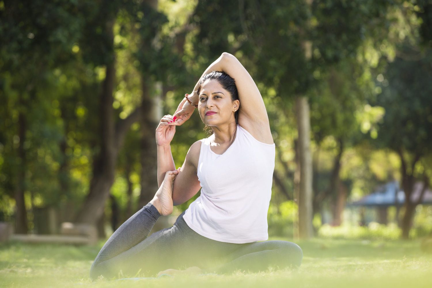 woman practicing yoga in park