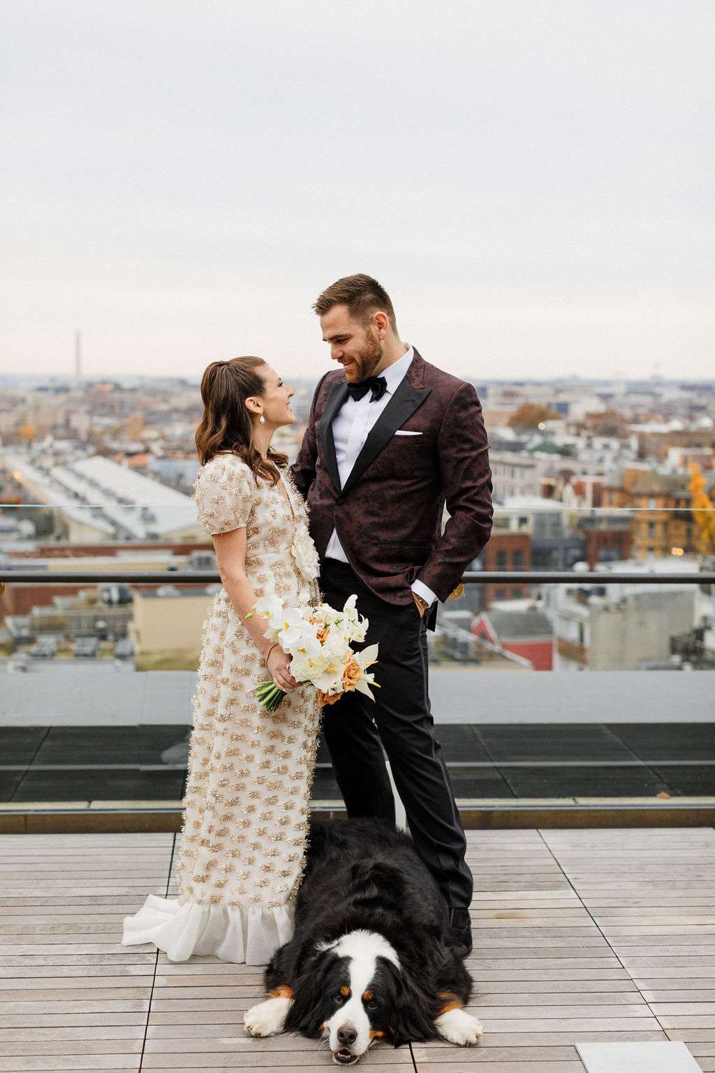 couple portrait on rooftop during first look with dog