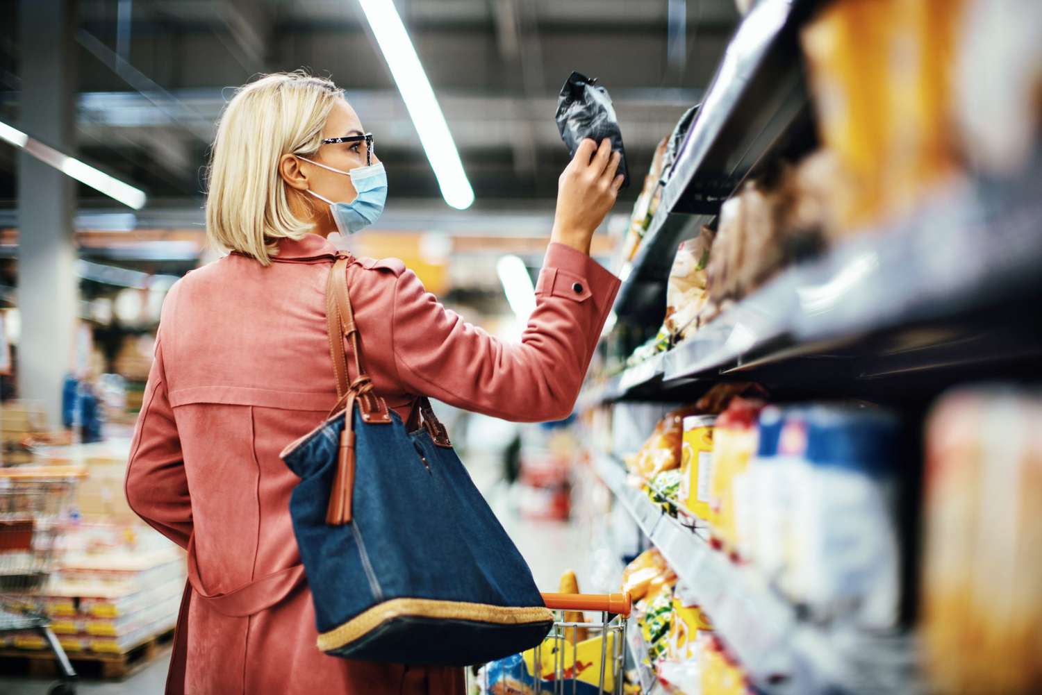 woman reading food label on back of package