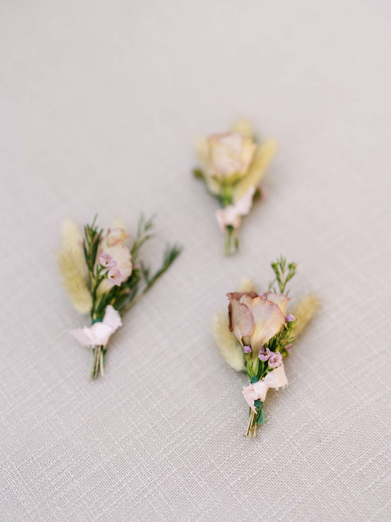 boutonniere with pink and purple flowers