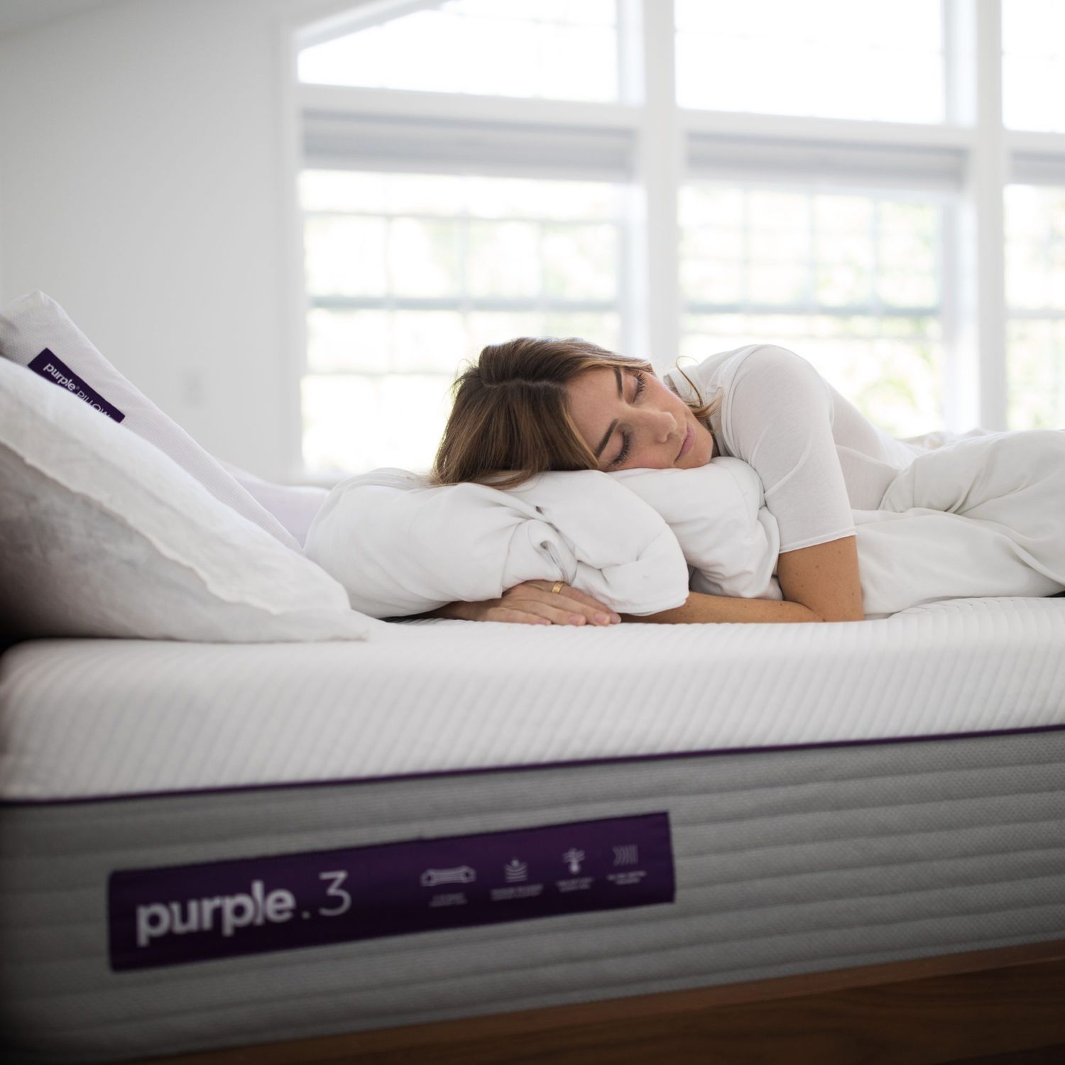 woman sleeping on purple mattress