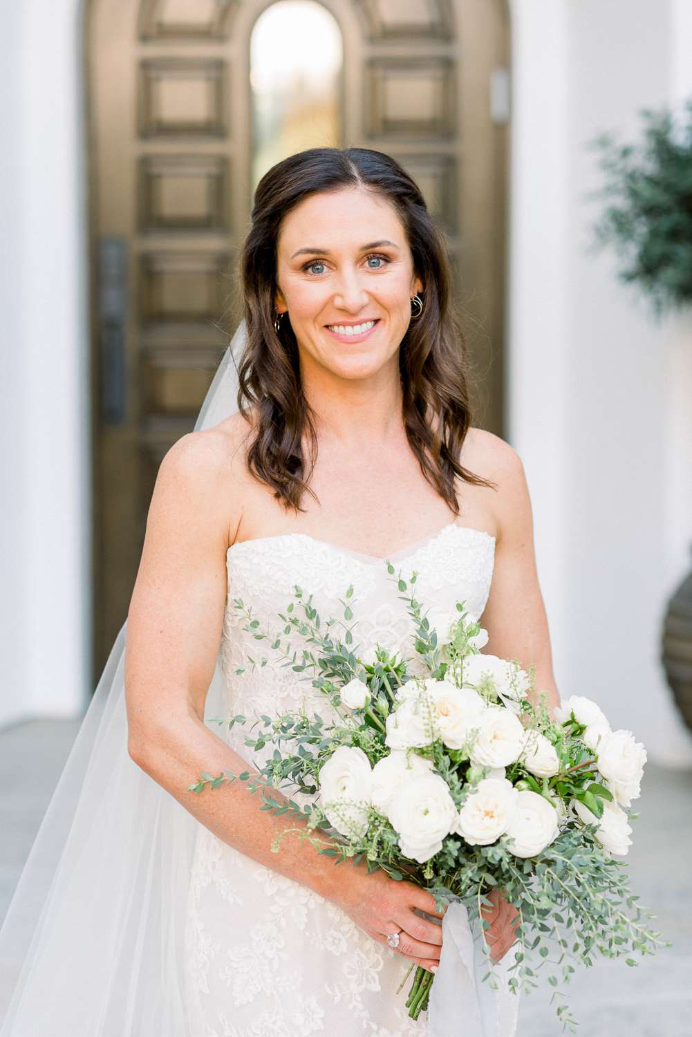 bride in strapless dress holding bouquet