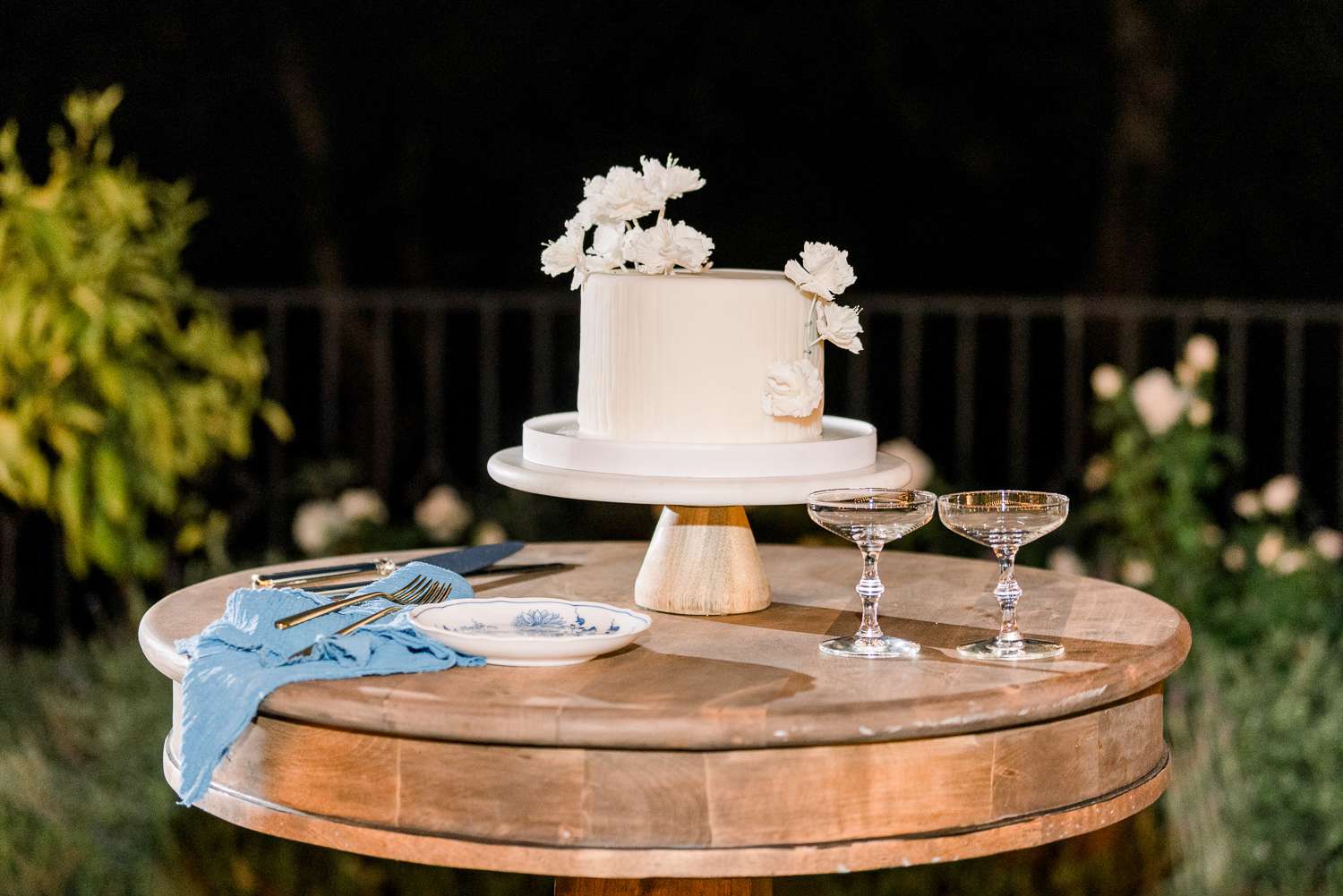 single-tier wedding cake on wooden table