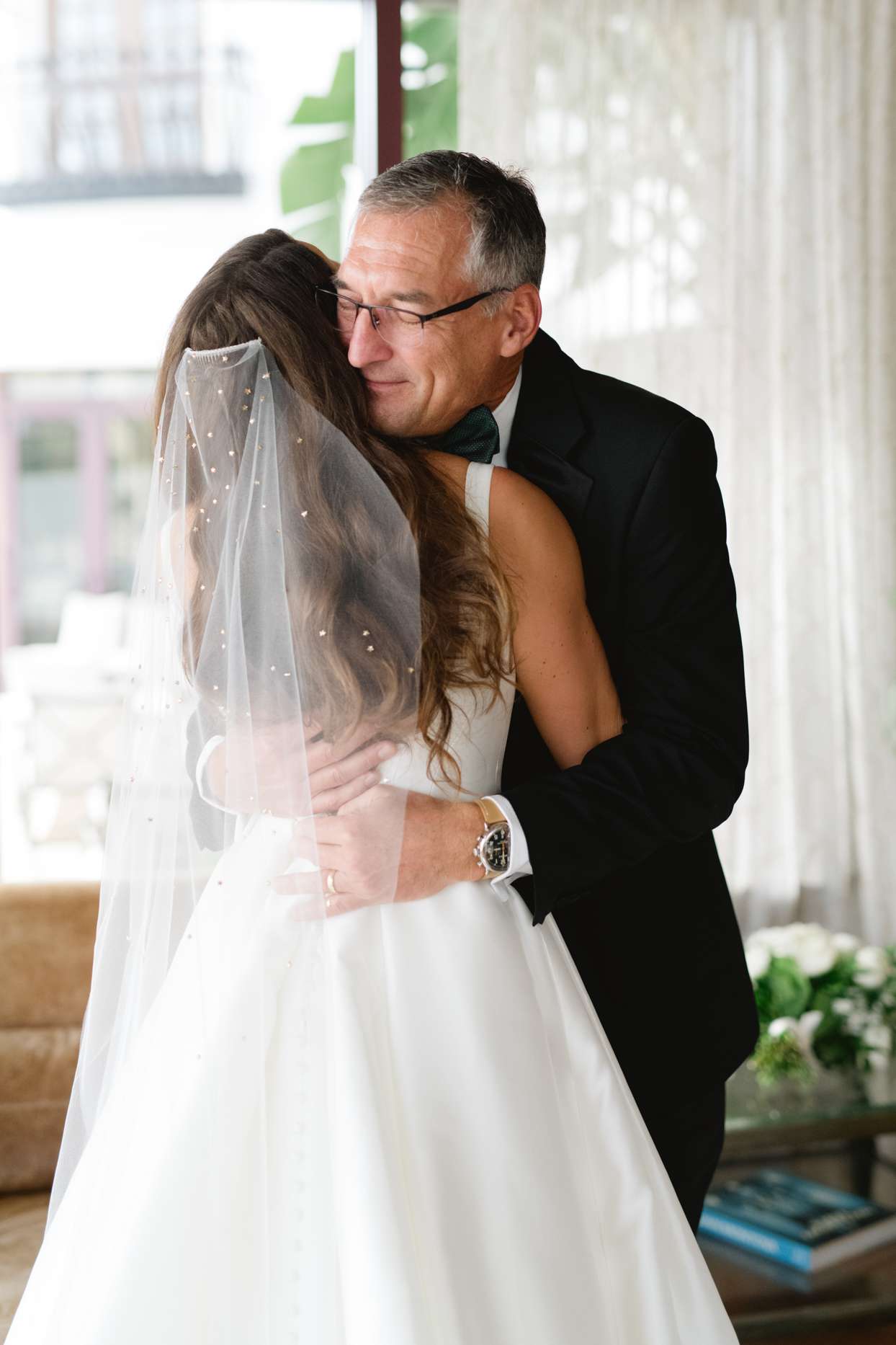 bride and father hugging before wedding