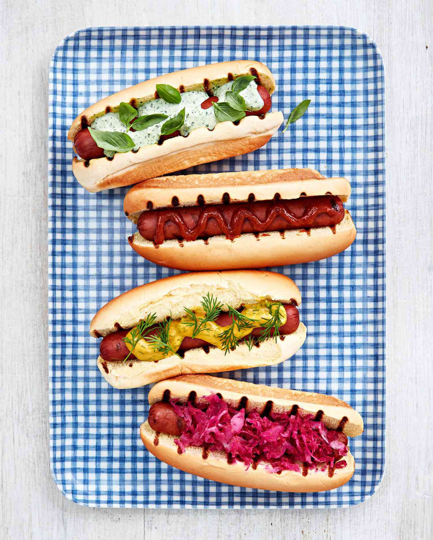hot dog varieties on blue checkered platter