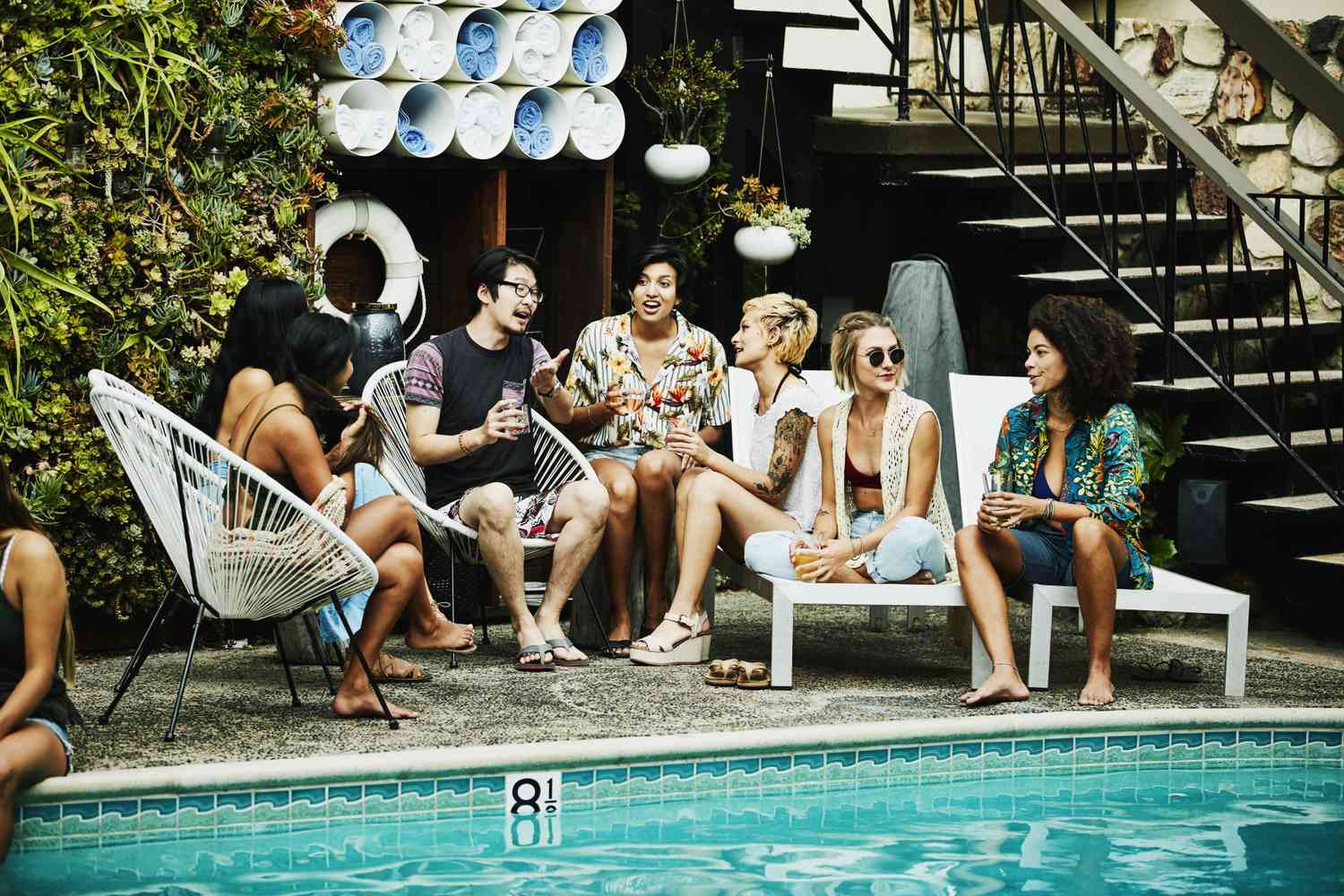 group of friends socializing by pool