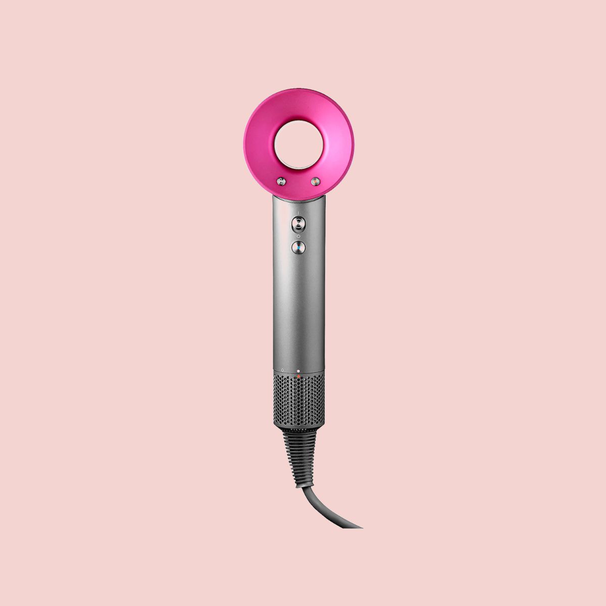 dyson hair dryer in front of pink background