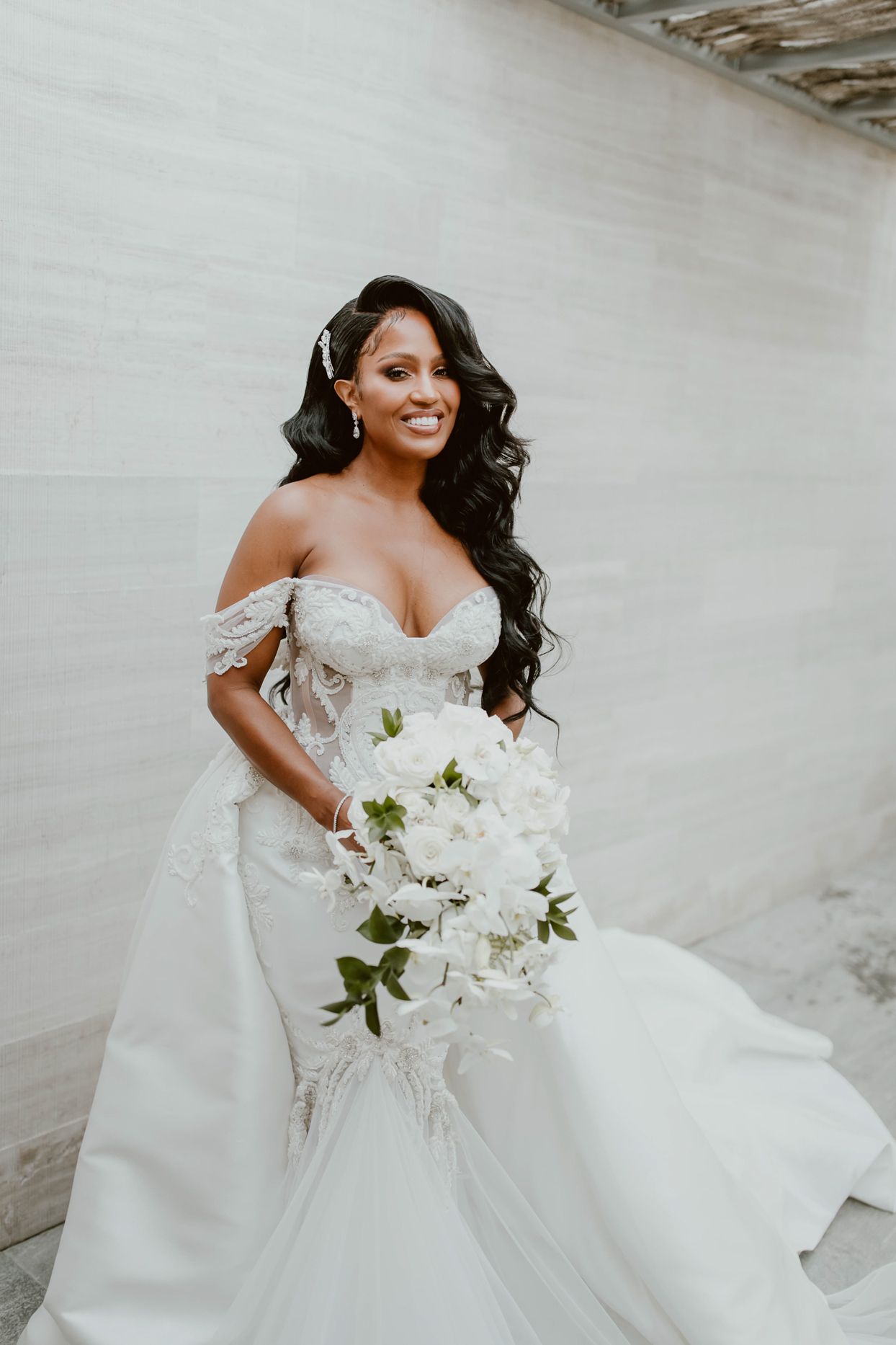 bride in elegant white dress holding flowers