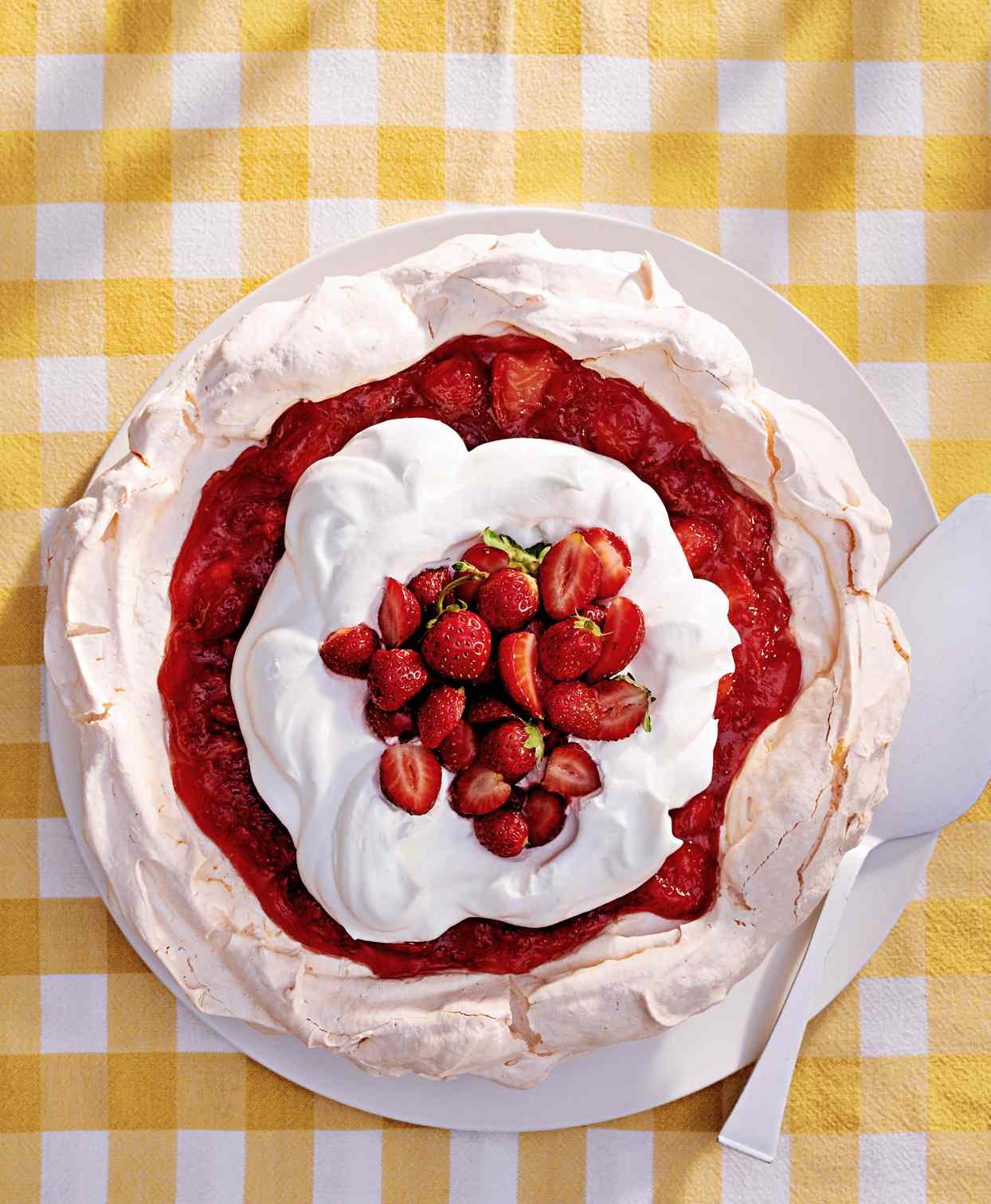 strawberry-lemonade angel pie topped with fresh strawberries