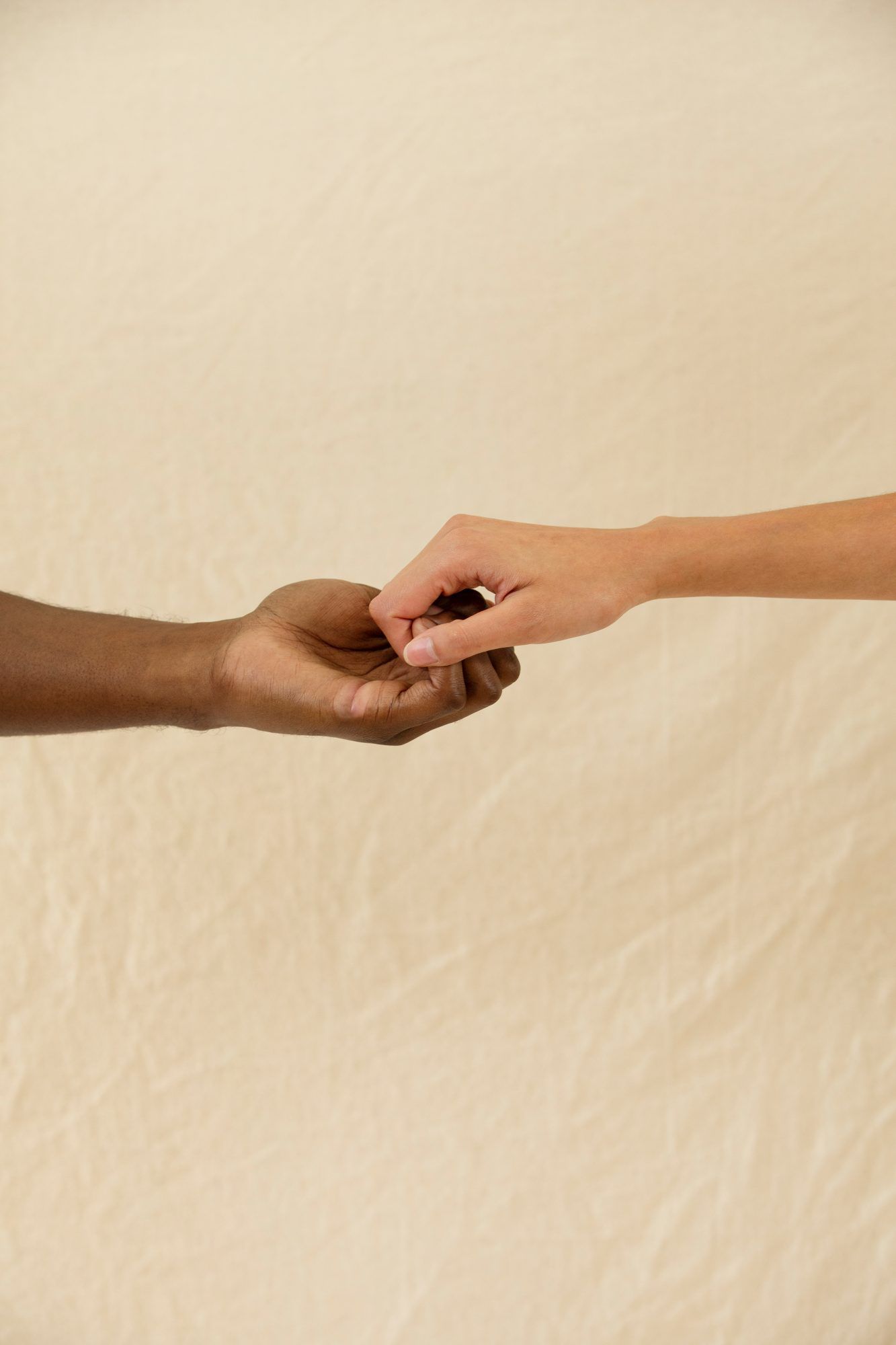 holding hands beige background