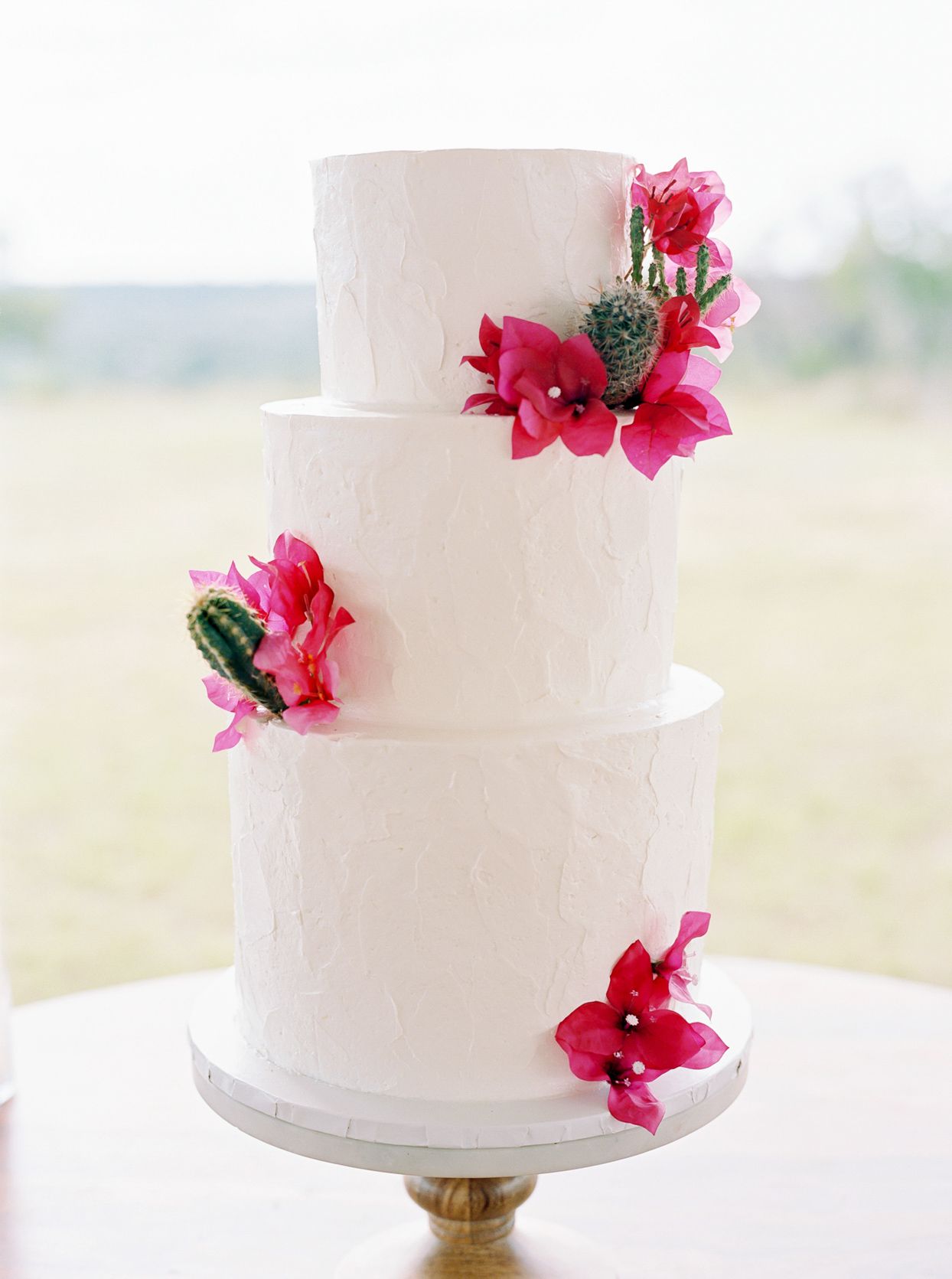 three-tiered wedding cake with flowers