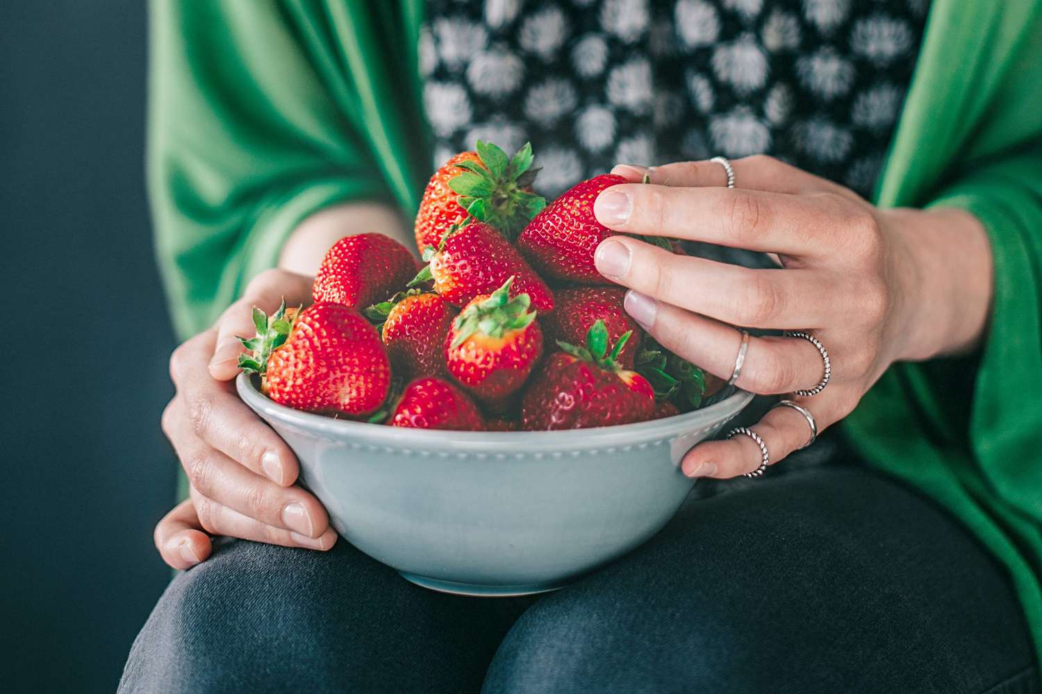 woman eating bowl of strawberries