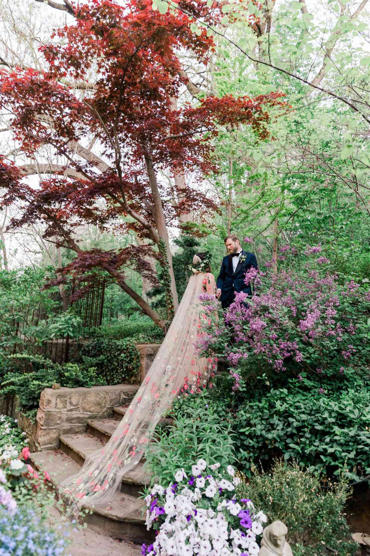 bride and groom on steps in garden