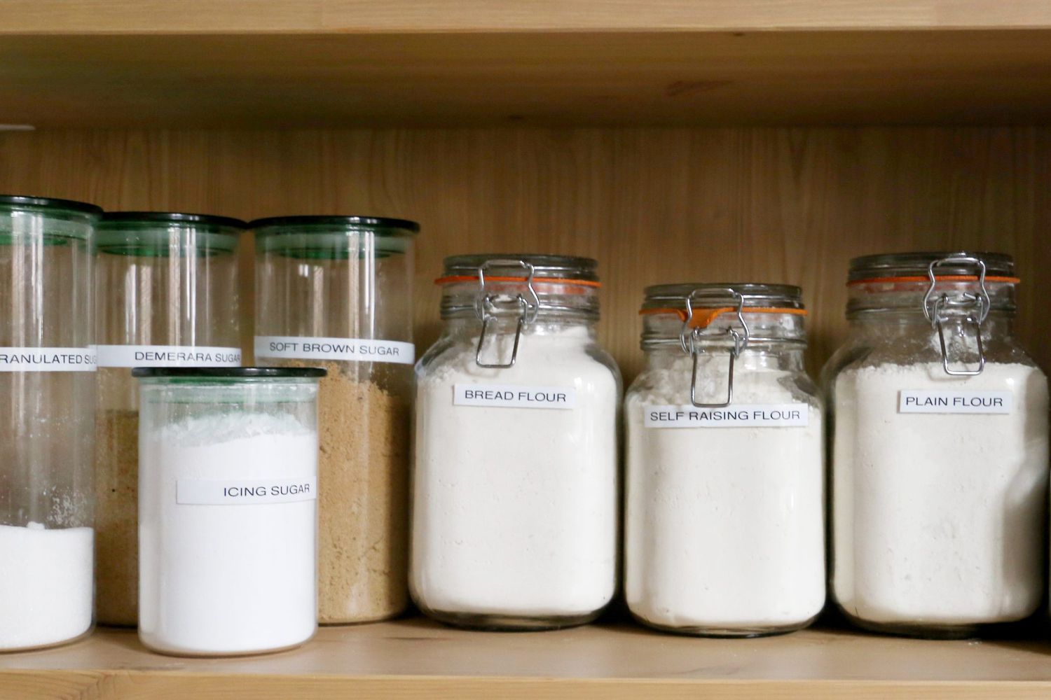 jars of flour and sugar on wood shelf