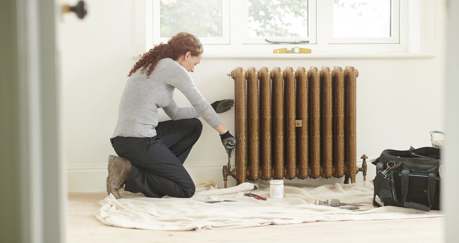 woman repairing leaky radiator