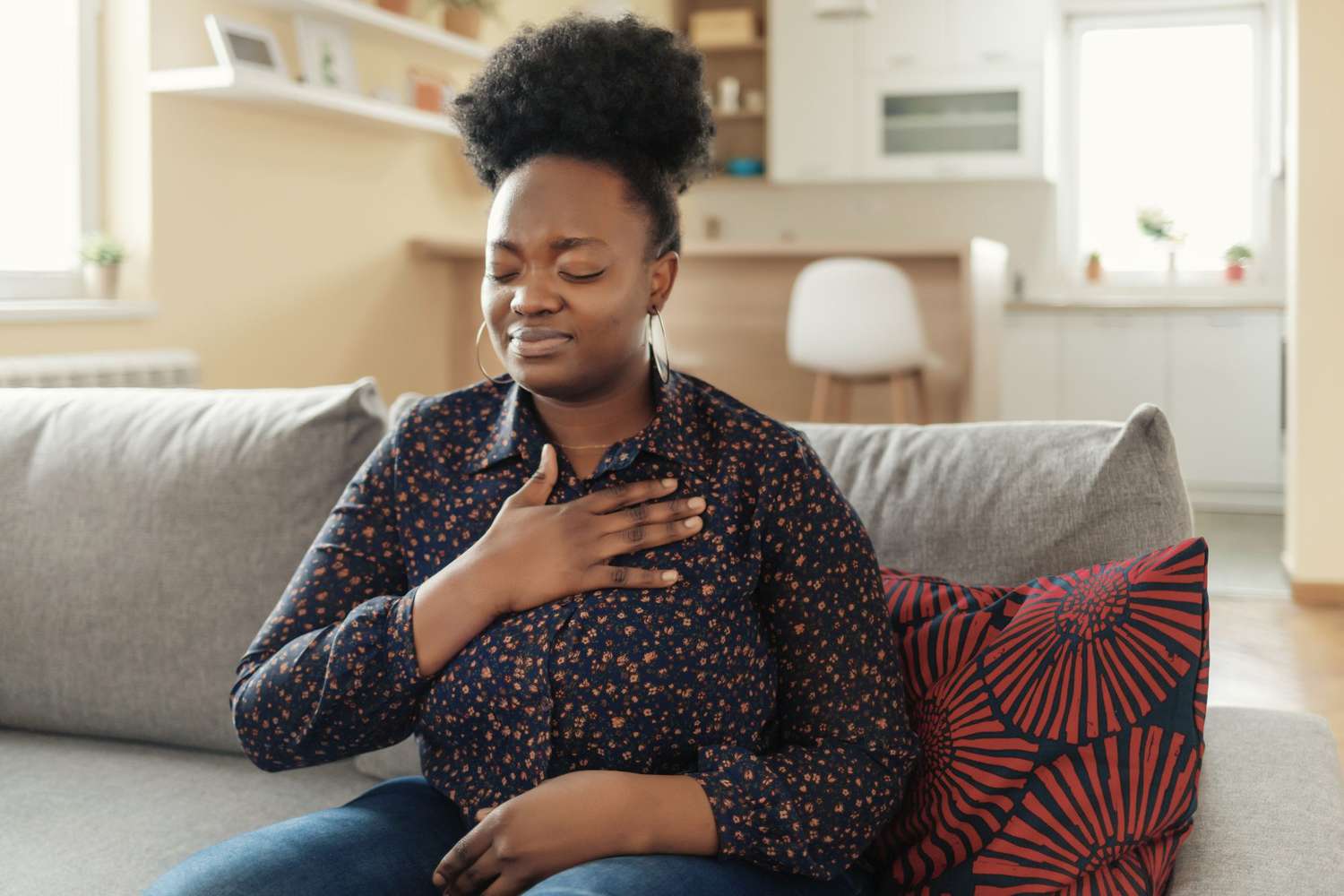 woman touching chest suffering from heartburn