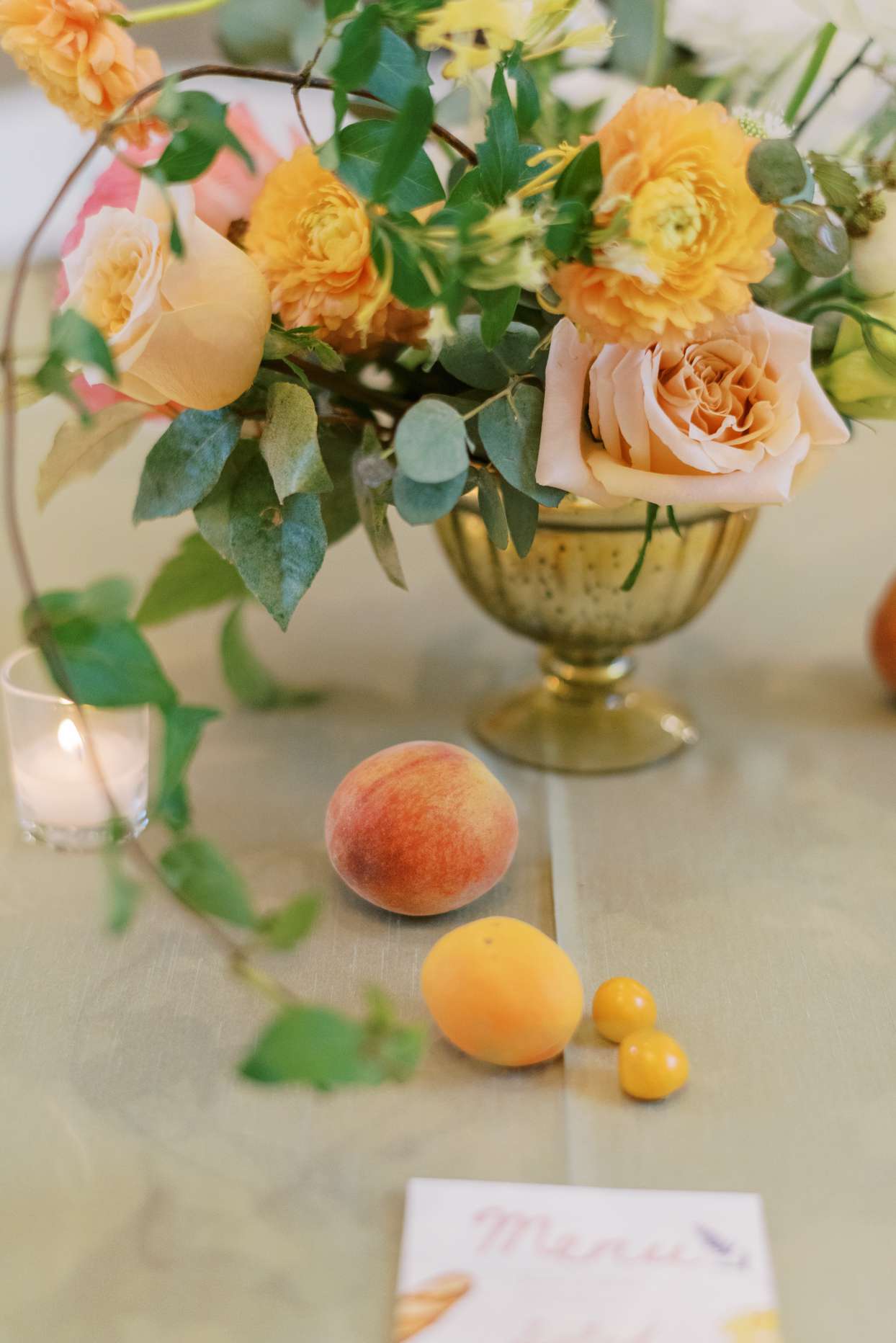 orange floral and fruit wedding reception centerpieces