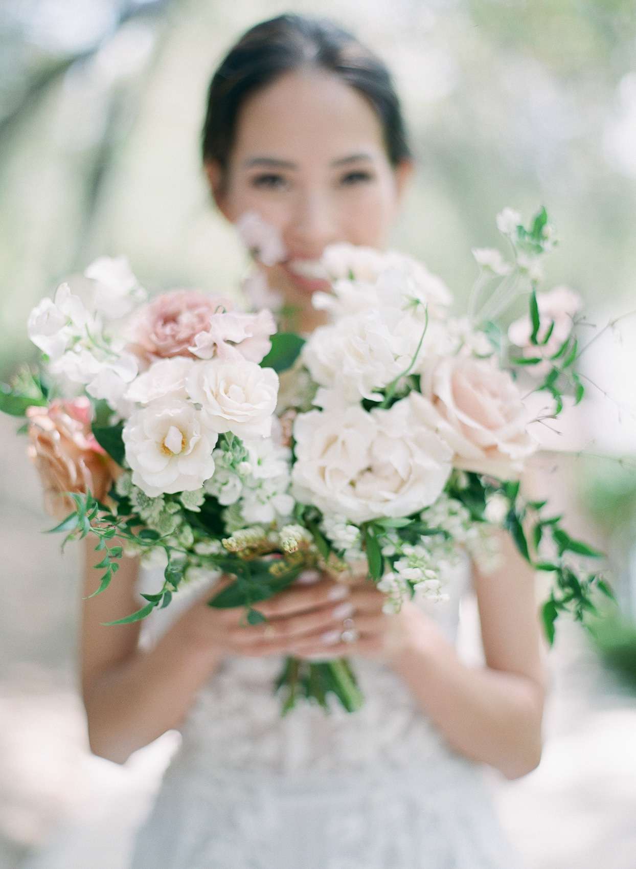 Bride holding bouquet with pink accents