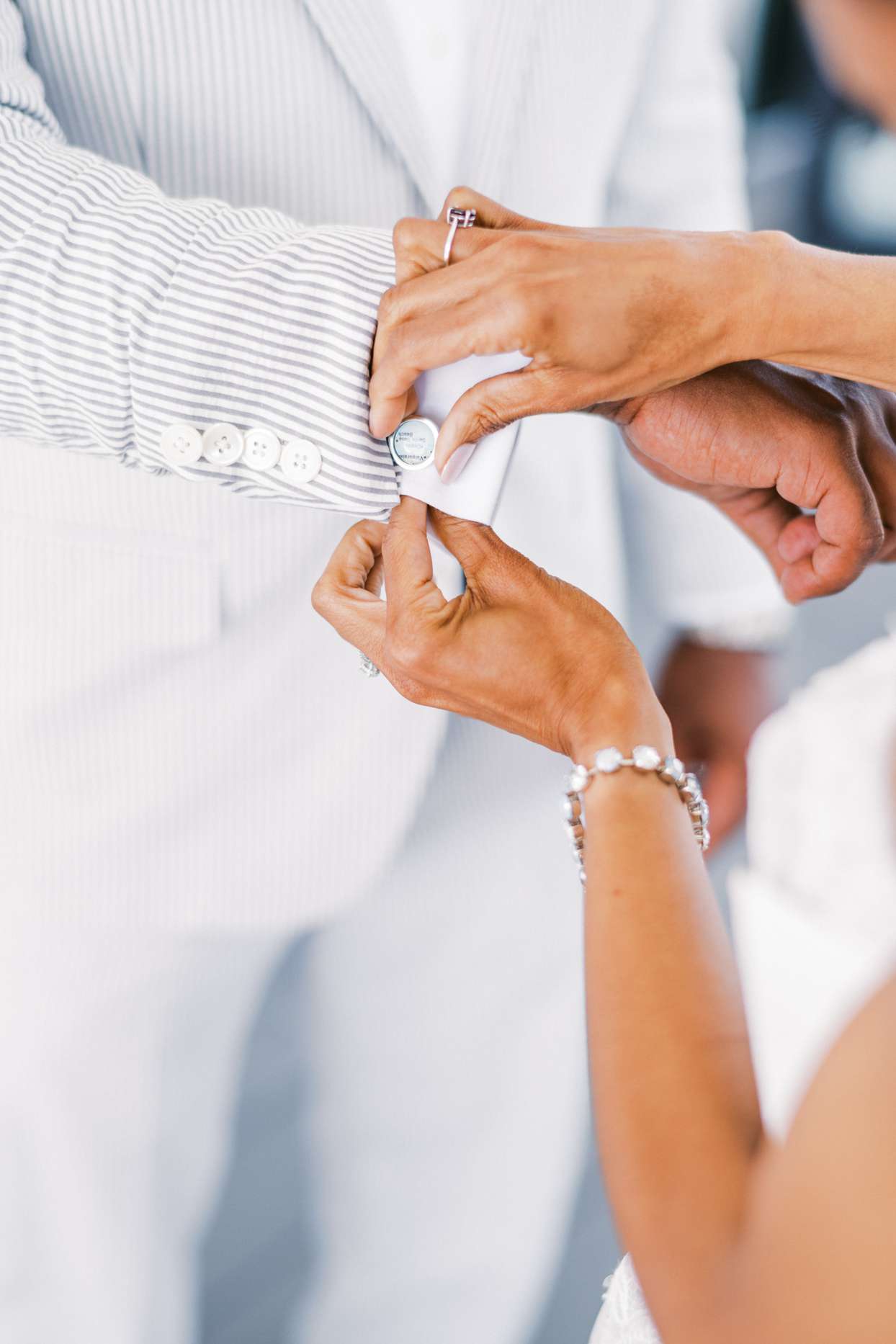 bride adjusting groom's cuff links