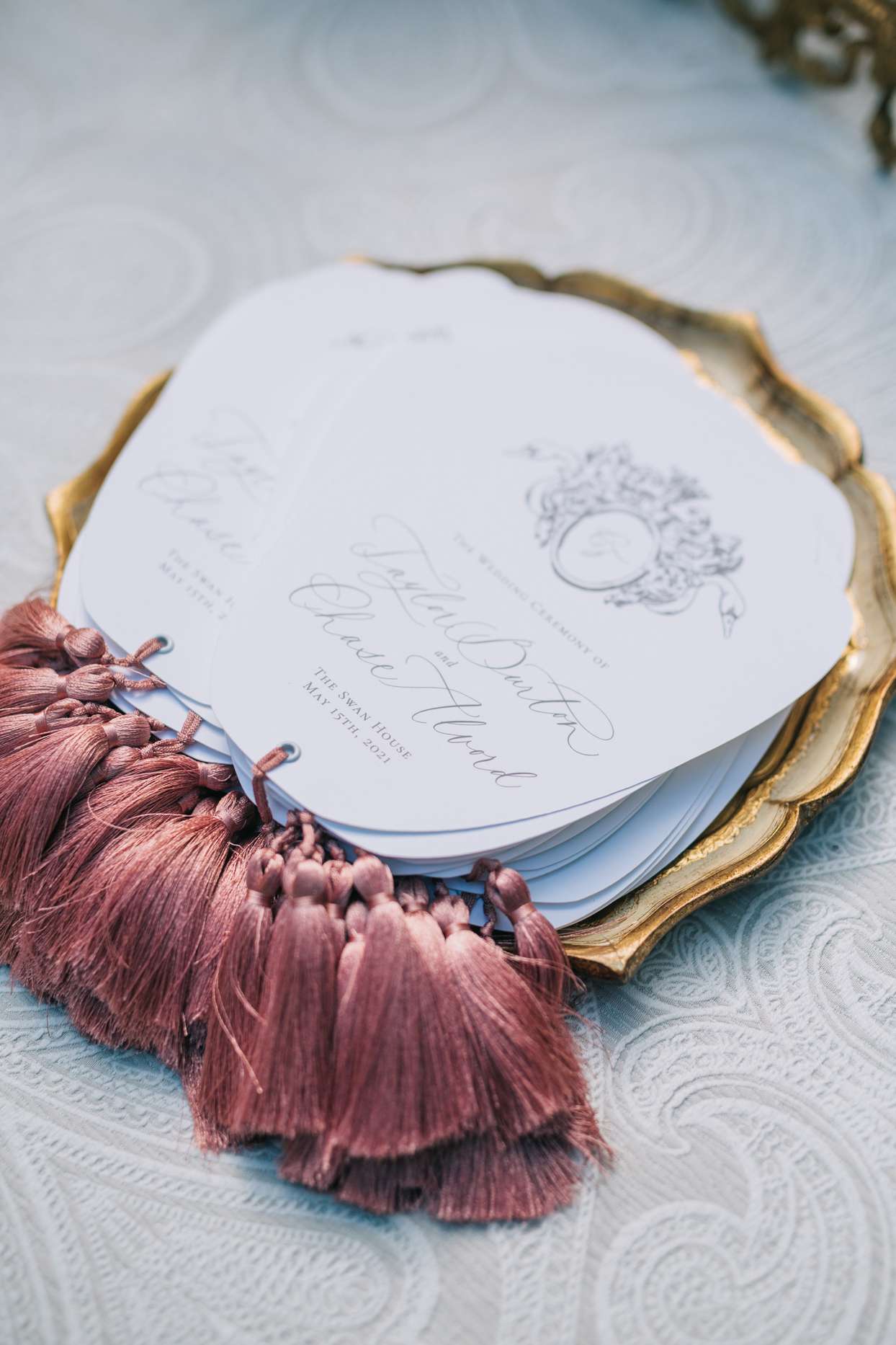 custom tassel wedding programs displayed on gold tray