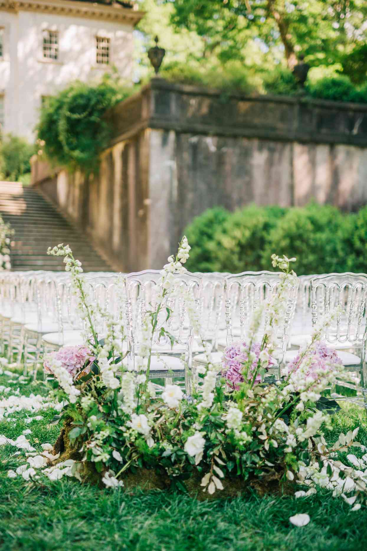 outdoor wedding ceremony setup with acrylic napoleon chairs