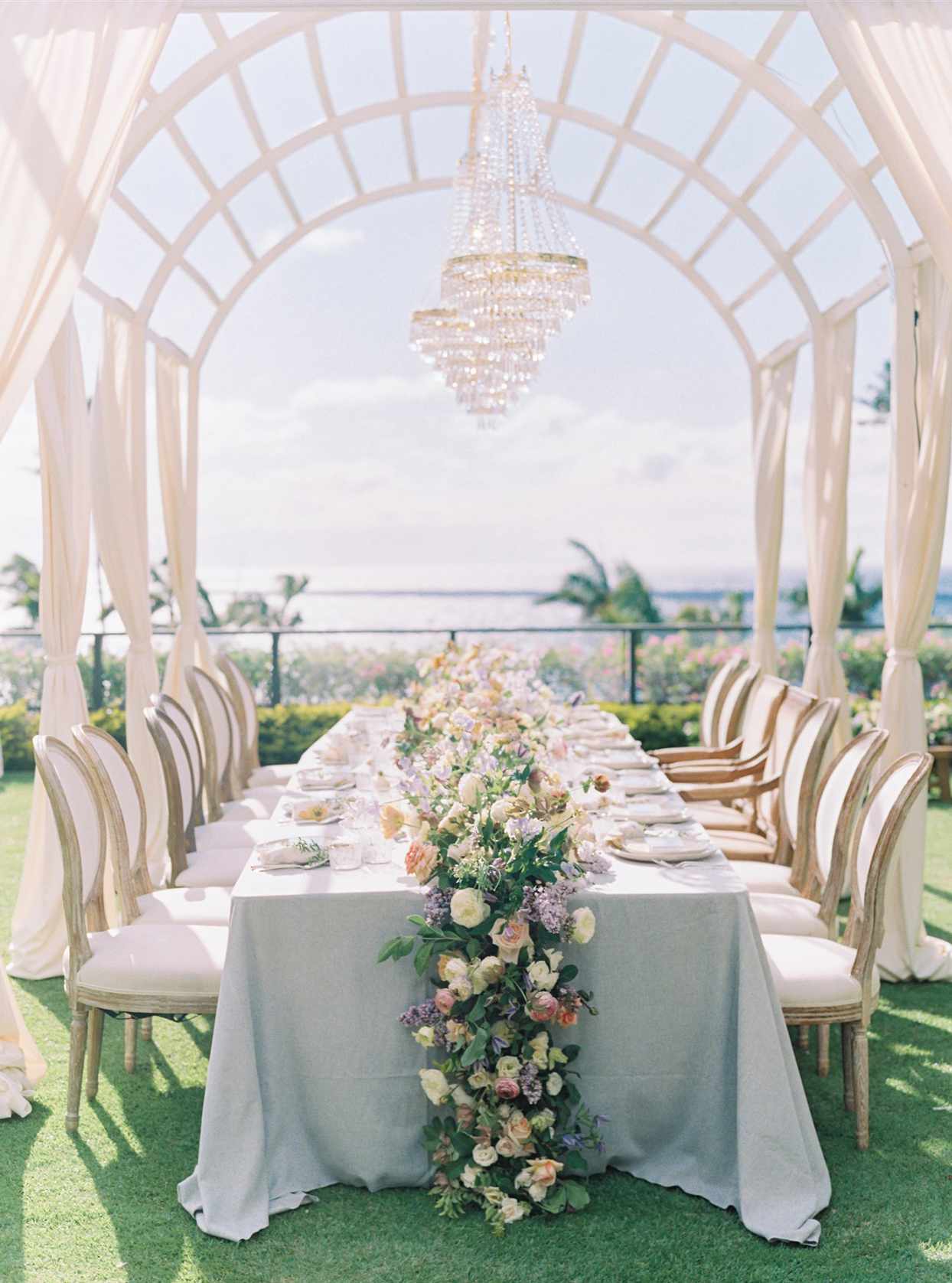 wedding reception table set up beneath beautiful arch