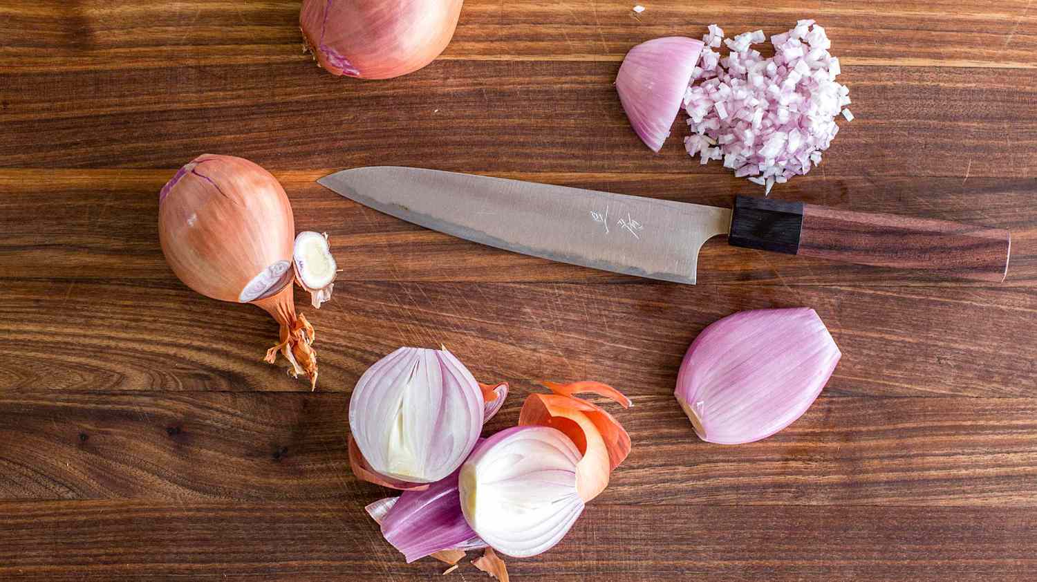 who and minced shallots on cutting board with knife
