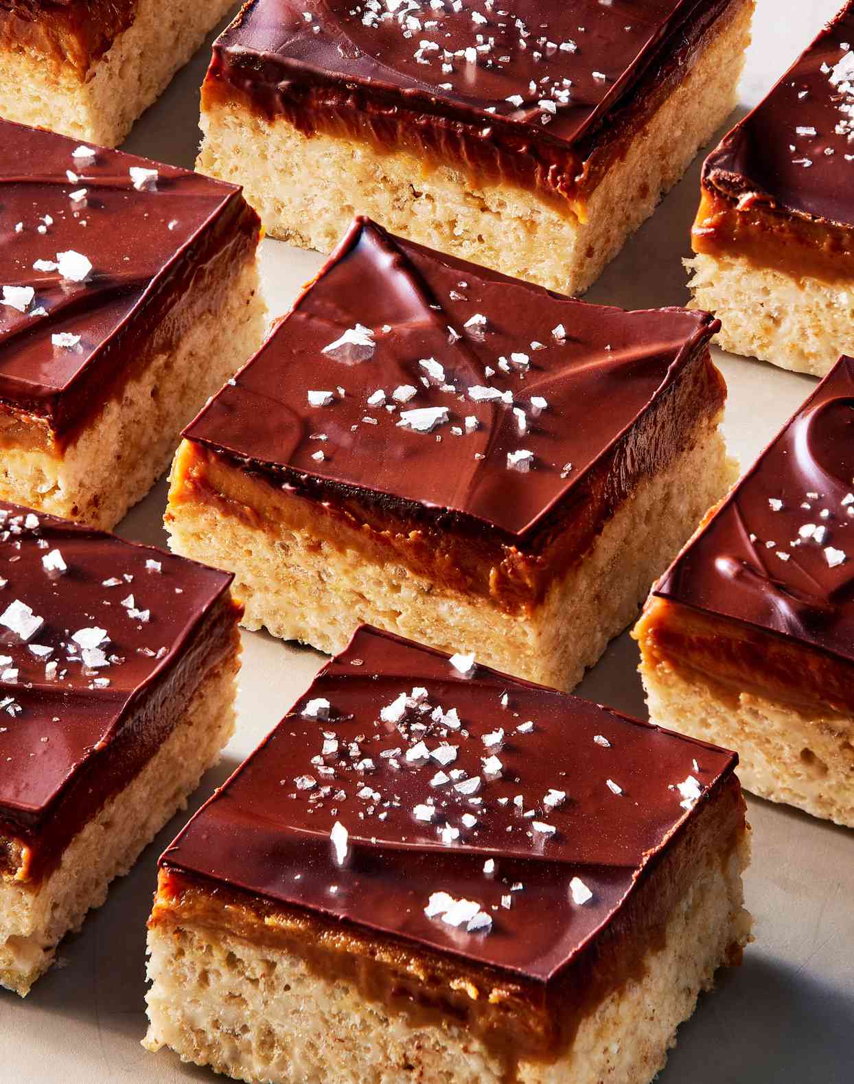 chocolate-peanut-butter-caramel cereal bars topped with flaky sea salt