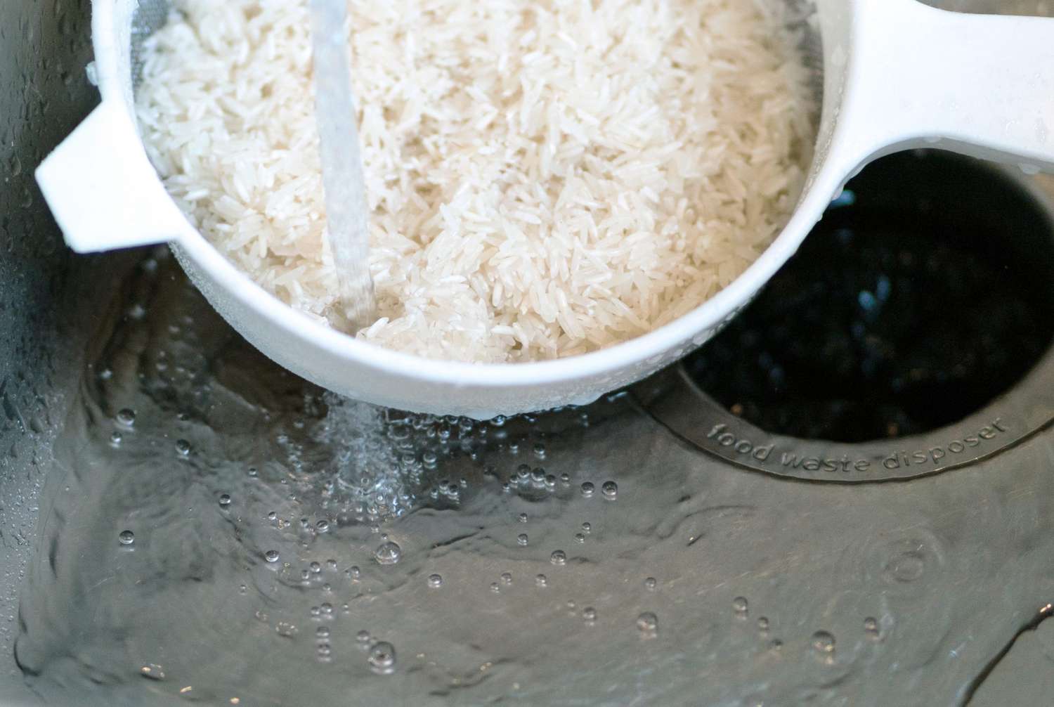 rinsing white rice in sink